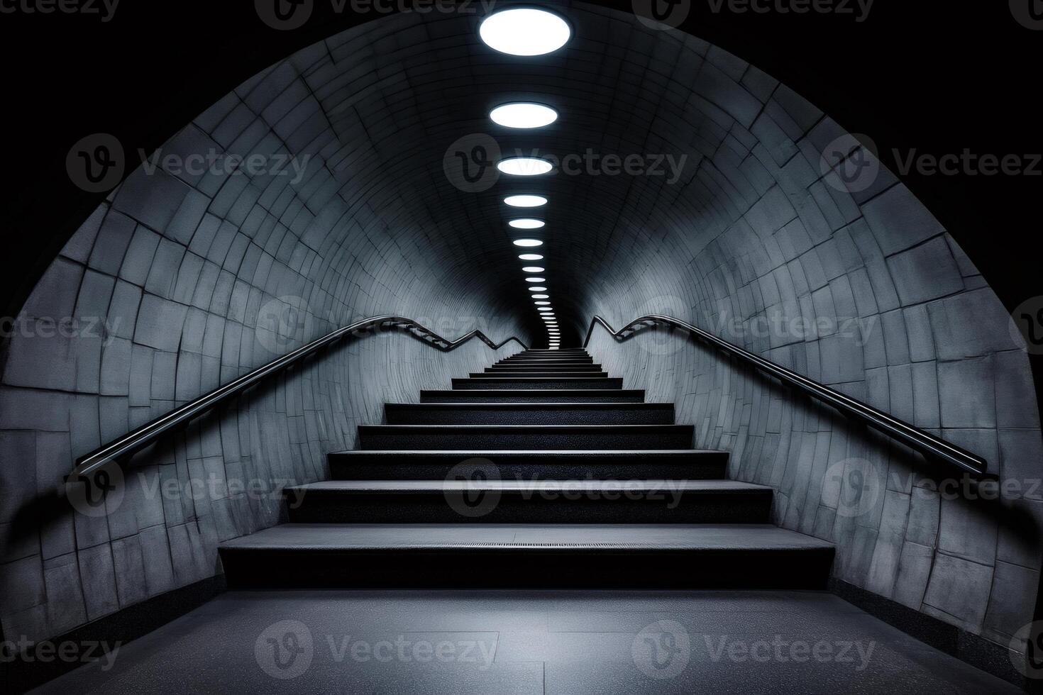 Long staircase going up in a dark tunnel with lights and handrail photo