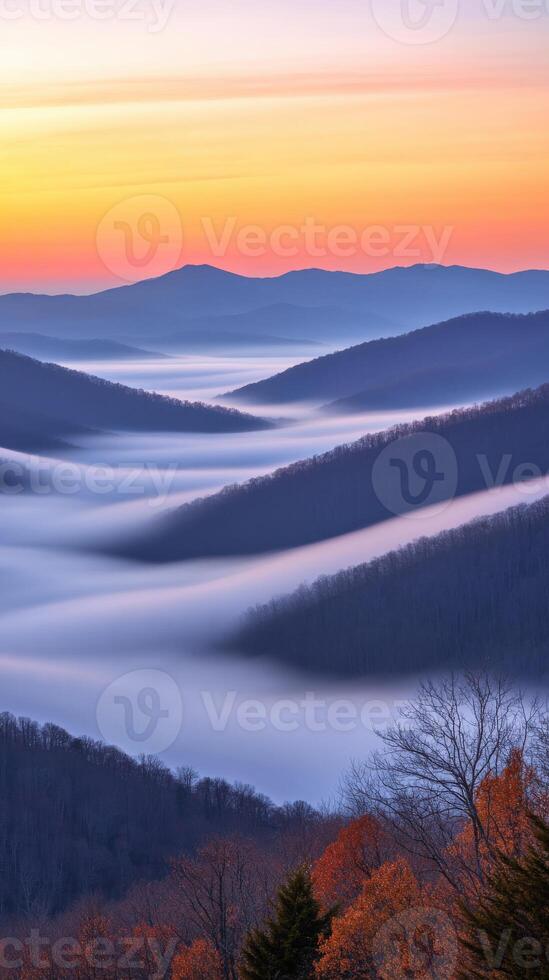 Majestic sunrise over rolling misty mountains photo