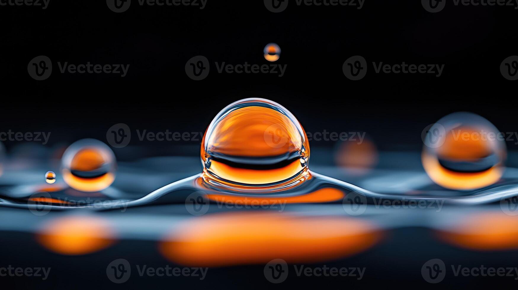 Orange water drops creating a big bubble on dark background photo