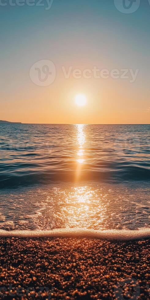 The sun setting over the ocean photo