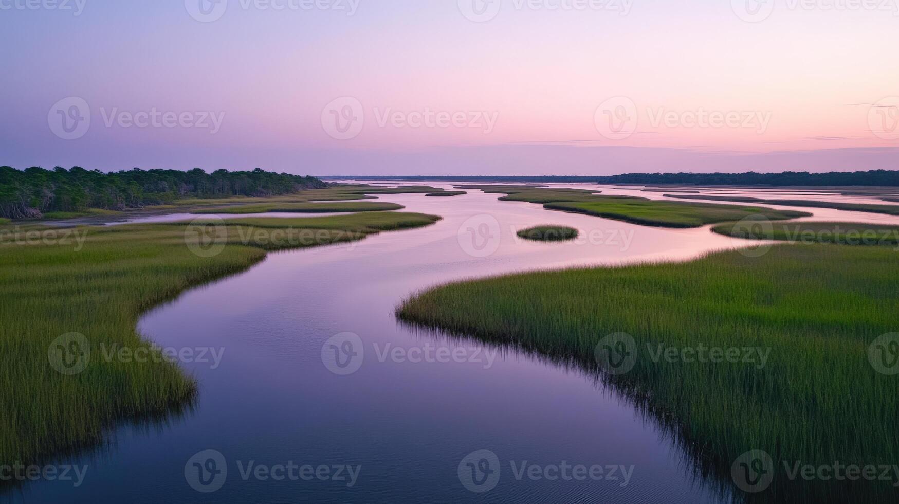 A river runs through a marsh at sunset photo