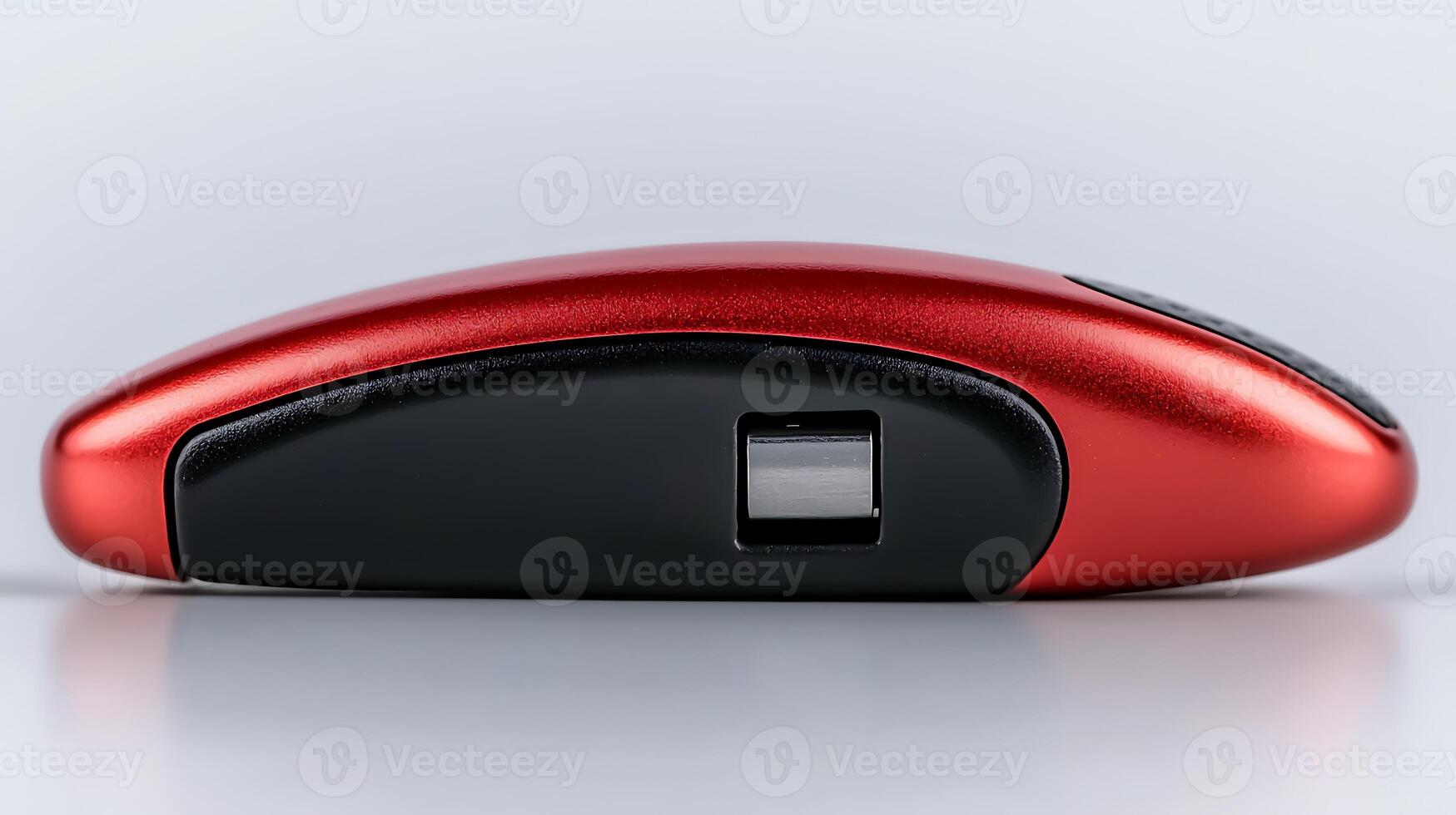 Sleek red wireless mouse on a smooth surface, showcasing modern design and technology photo