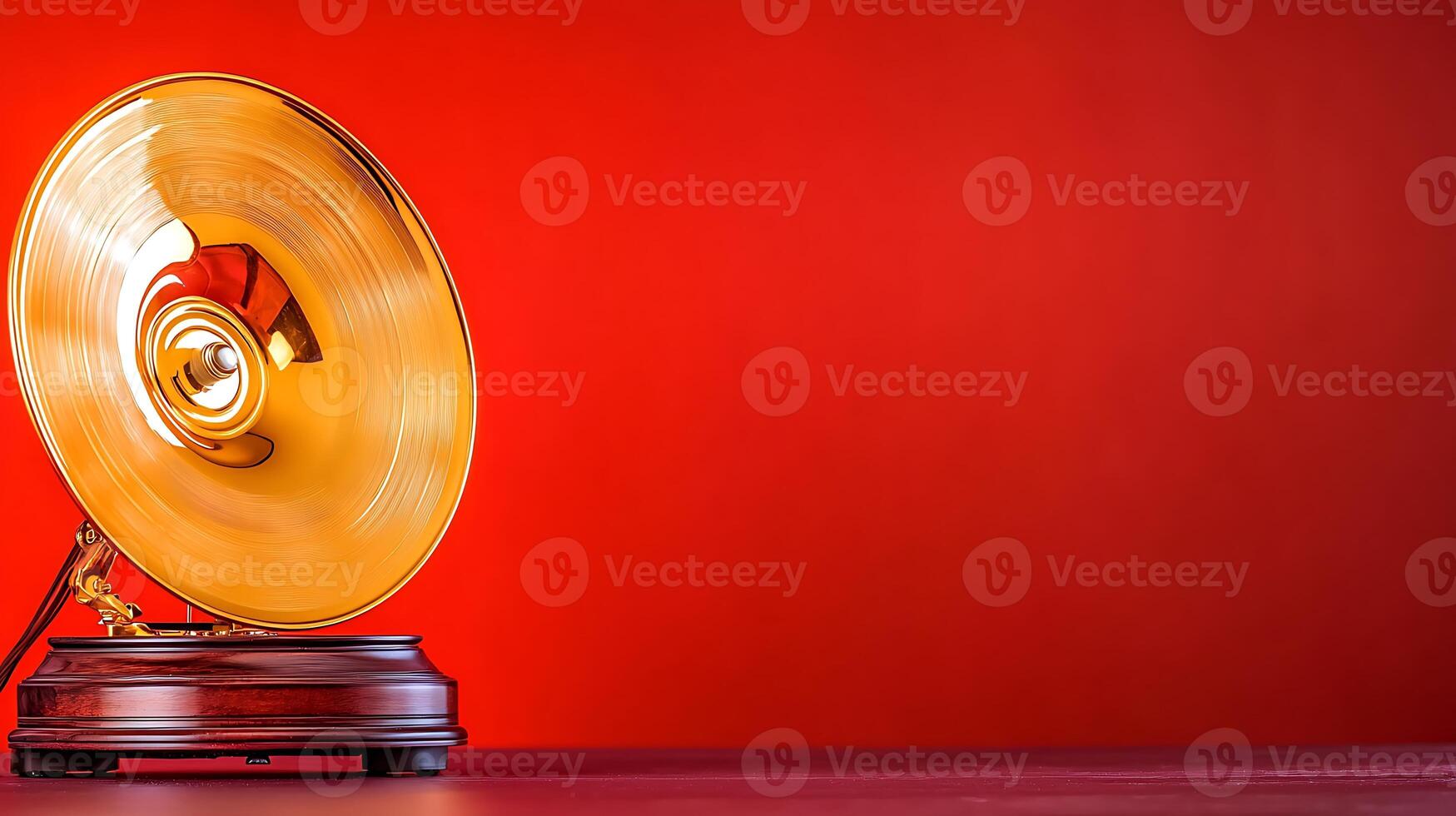 Vintage gramophone with a golden horn on a vibrant red background, evoking nostalgia and music photo