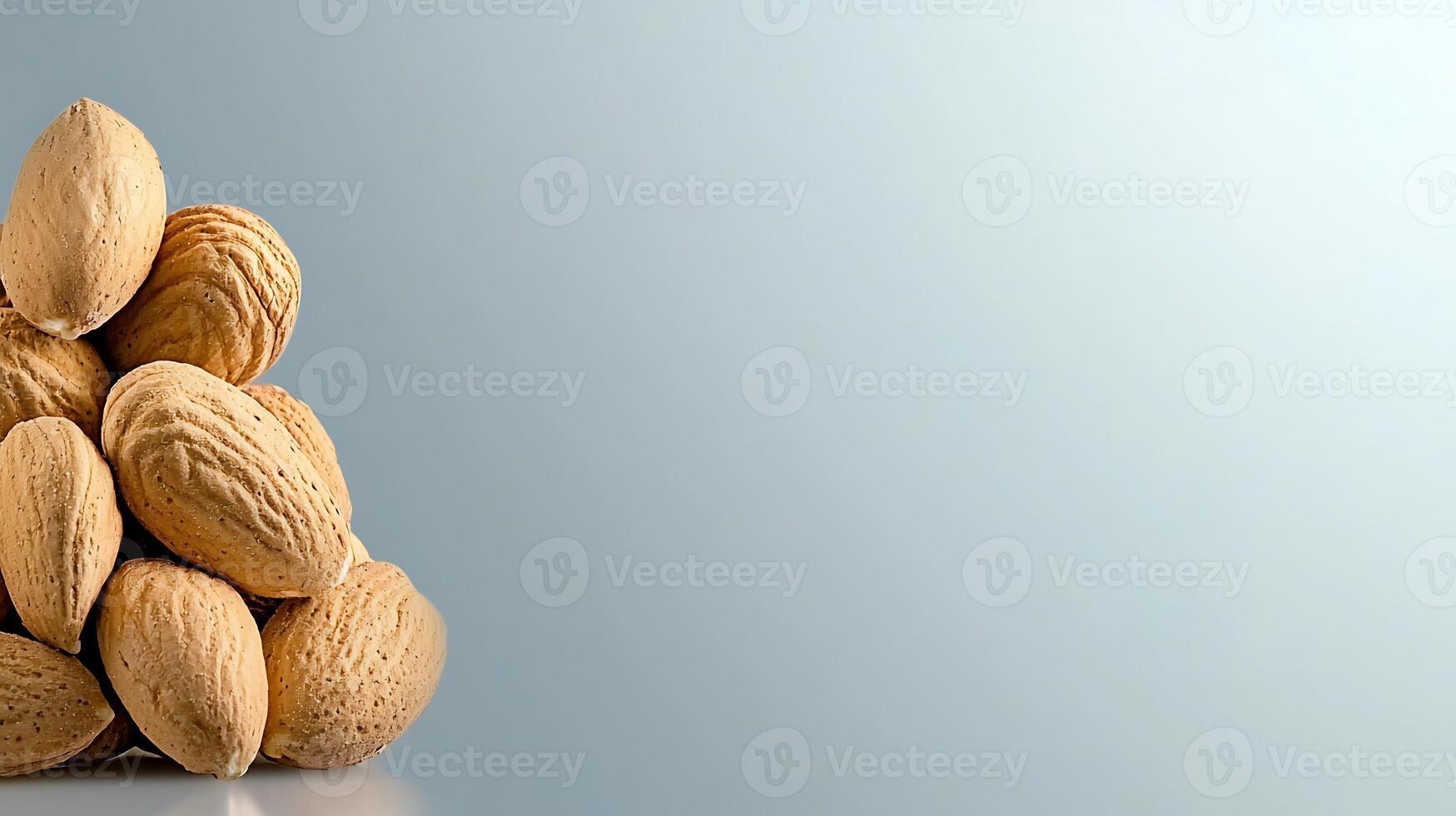 A close-up view of a pile of almonds on a soft gradient background, showcasing their natural texture photo