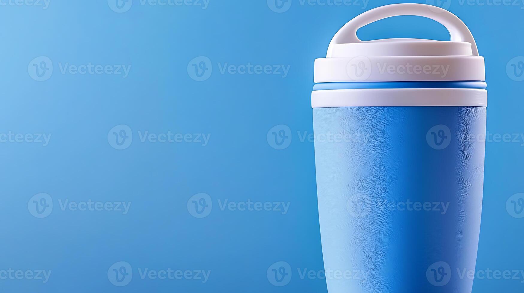 A vibrant blue travel mug stands against a solid blue background, ideal for beverage enjoyment photo