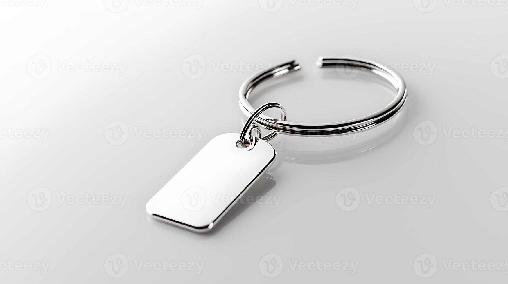 Silver keychain with a blank tag on a smooth, reflective surface, ideal for customization photo