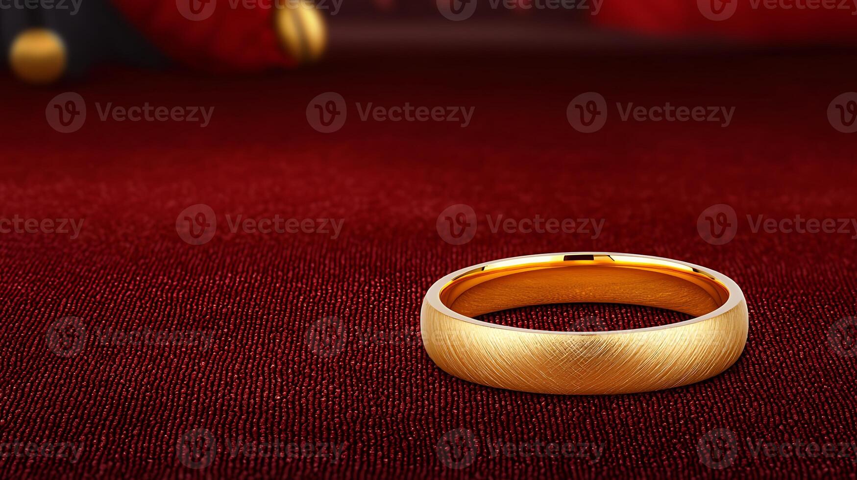 A close-up of a polished gold wedding band resting on a rich red velvet surface with decorative elements photo