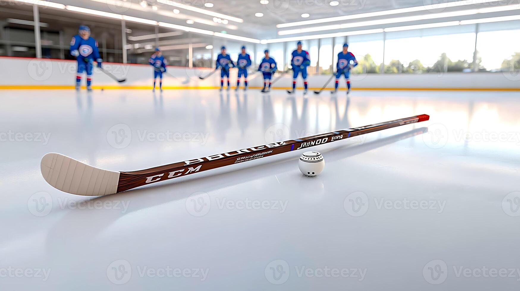 Hockey players in blue uniforms practice on an ice rink with a stick and puck in focus photo