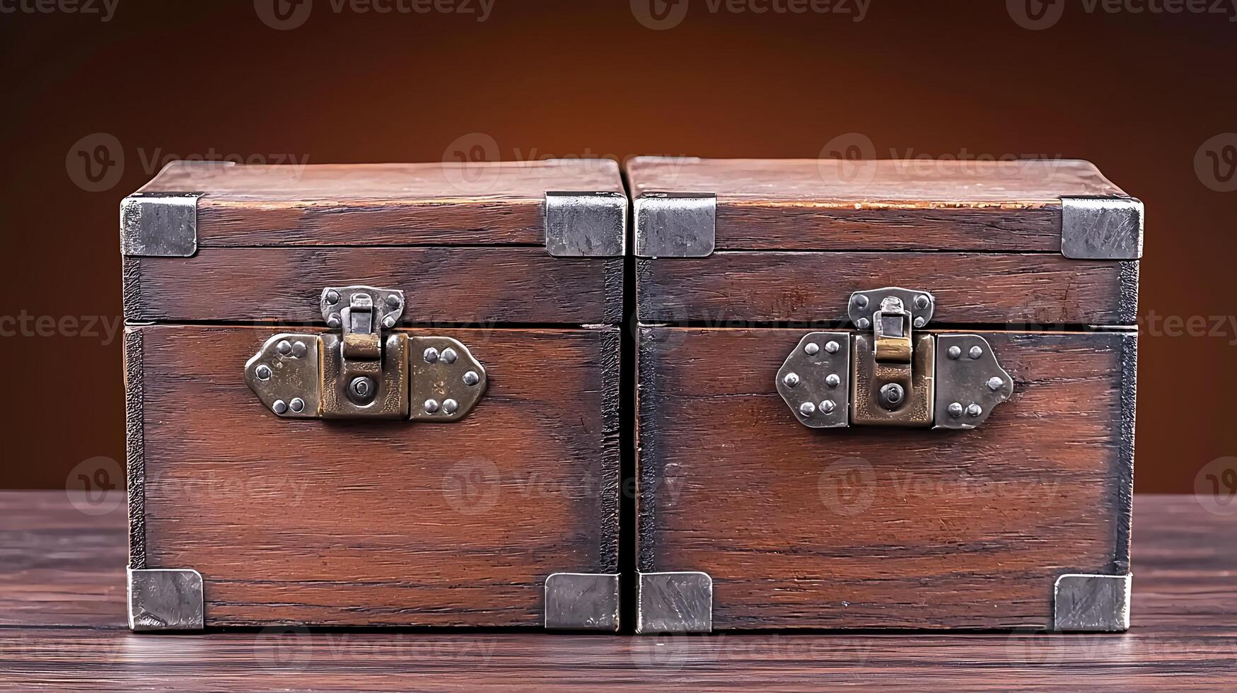 Two antique wooden boxes with metal clasps displayed on a wooden table against a warm background photo