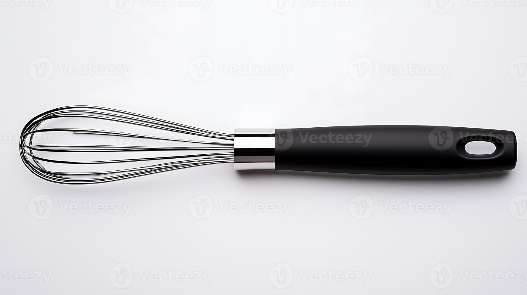 Stainless steel whisk with a black handle on a clean white background, ideal for kitchen use photo