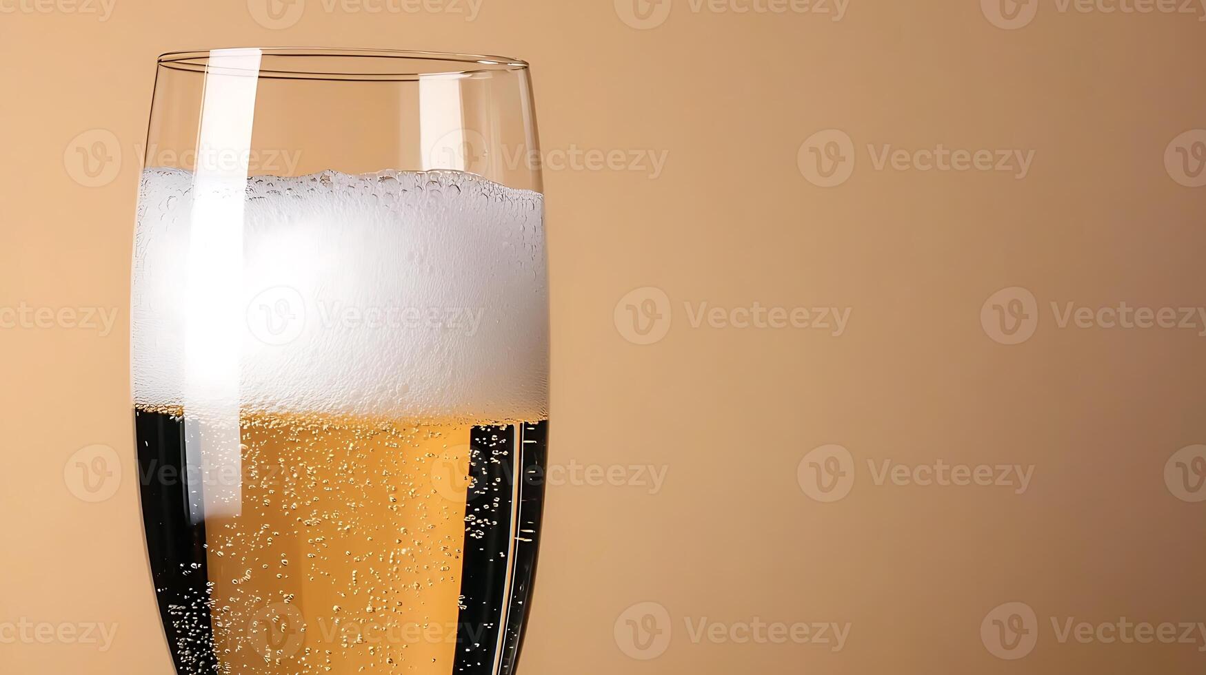 A close-up of a sparkling glass of beer with bubbles, set against a soft beige background photo