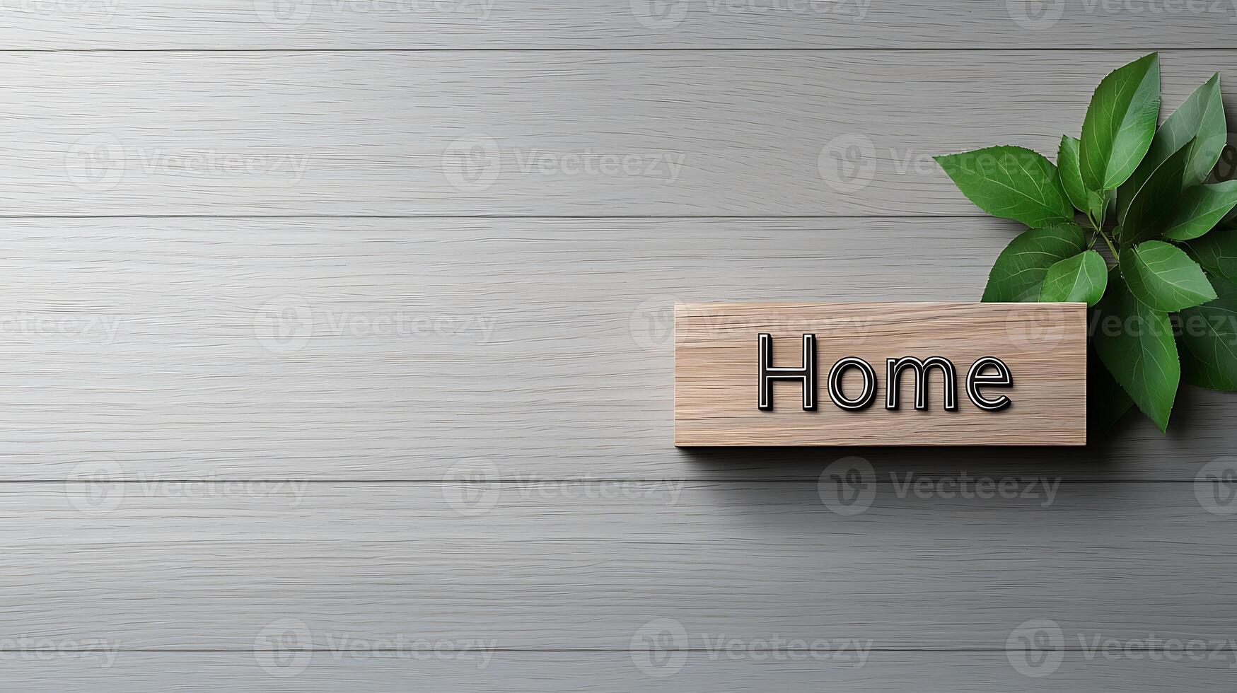 Wooden sign reading 'Home' placed on a light wooden surface with green leaves beside it photo