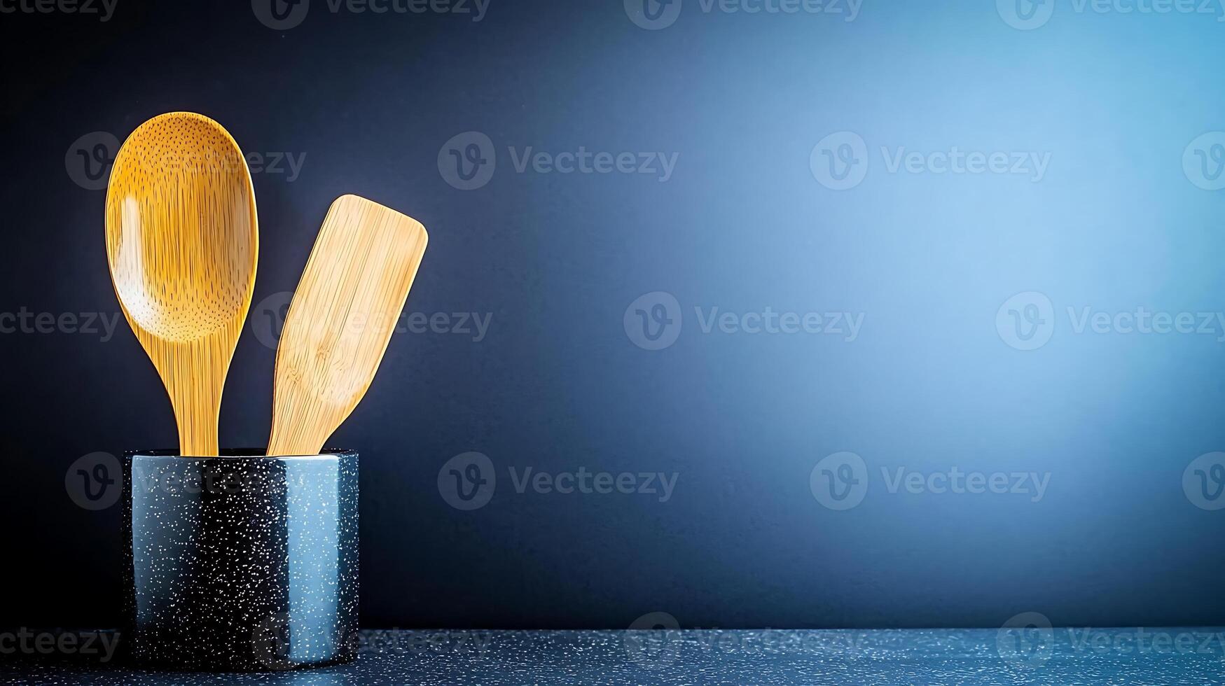 Wooden cooking utensils in a stylish holder against a gradient blue background, ideal for culinary themes photo