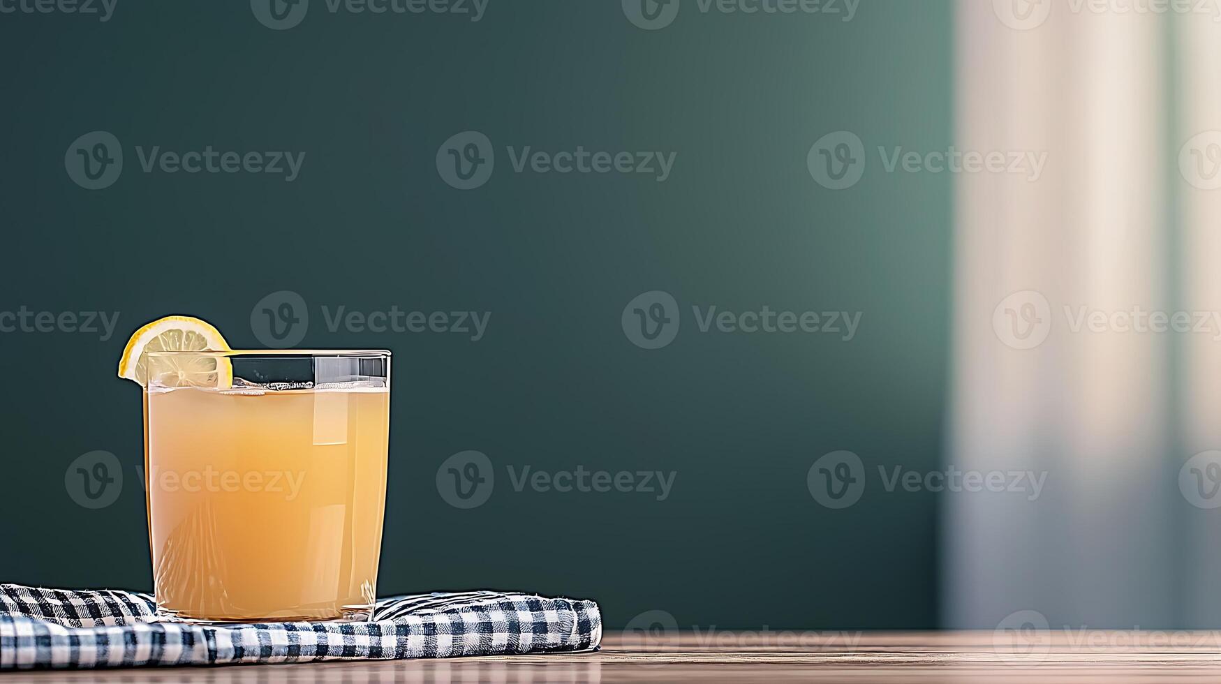 Refreshing citrus drink on a wooden table with a checkered napkin and soft background light photo