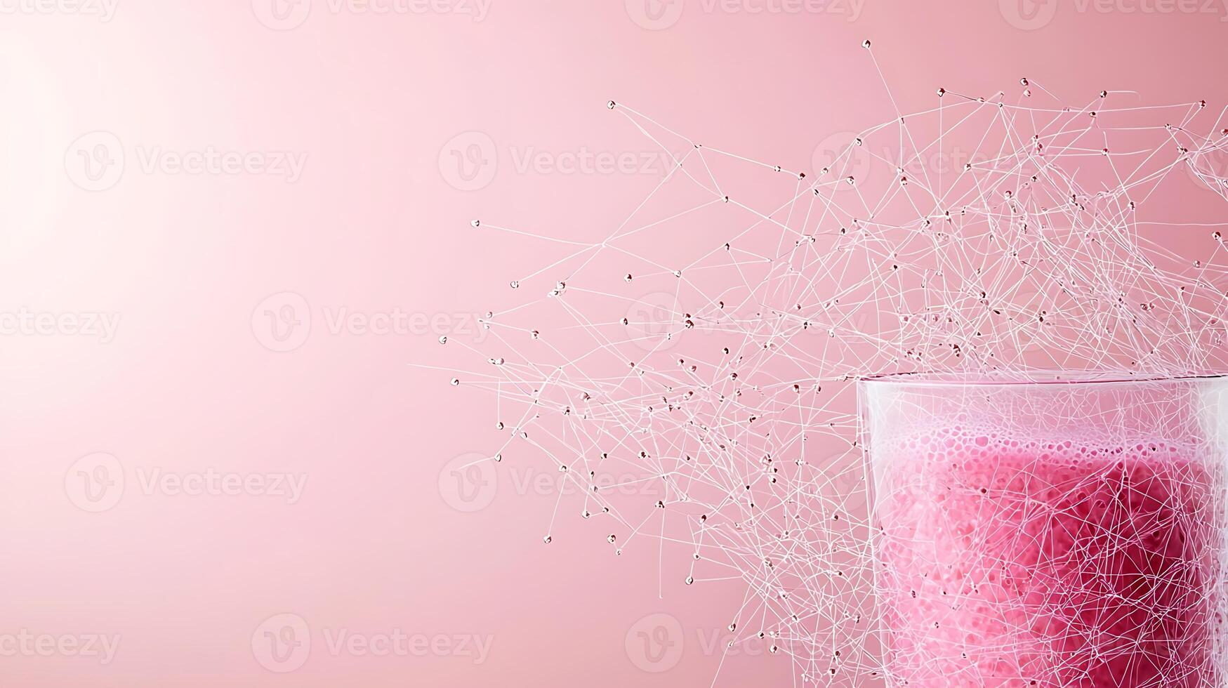 Refreshing pink beverage in a glass with abstract network design on a soft pink background photo