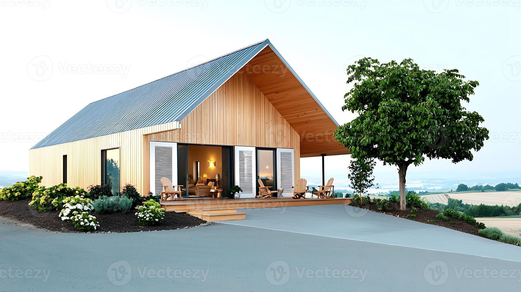 Modern wooden house with a porch, surrounded by greenery and scenic landscape in the background photo