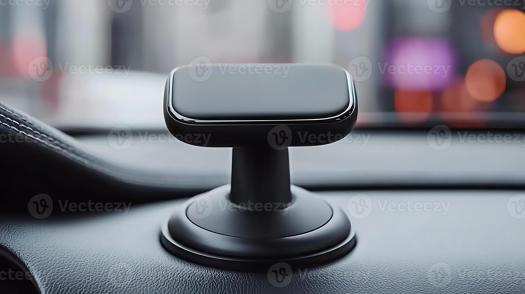 Sleek car phone mount positioned on dashboard with blurred city lights in background photo