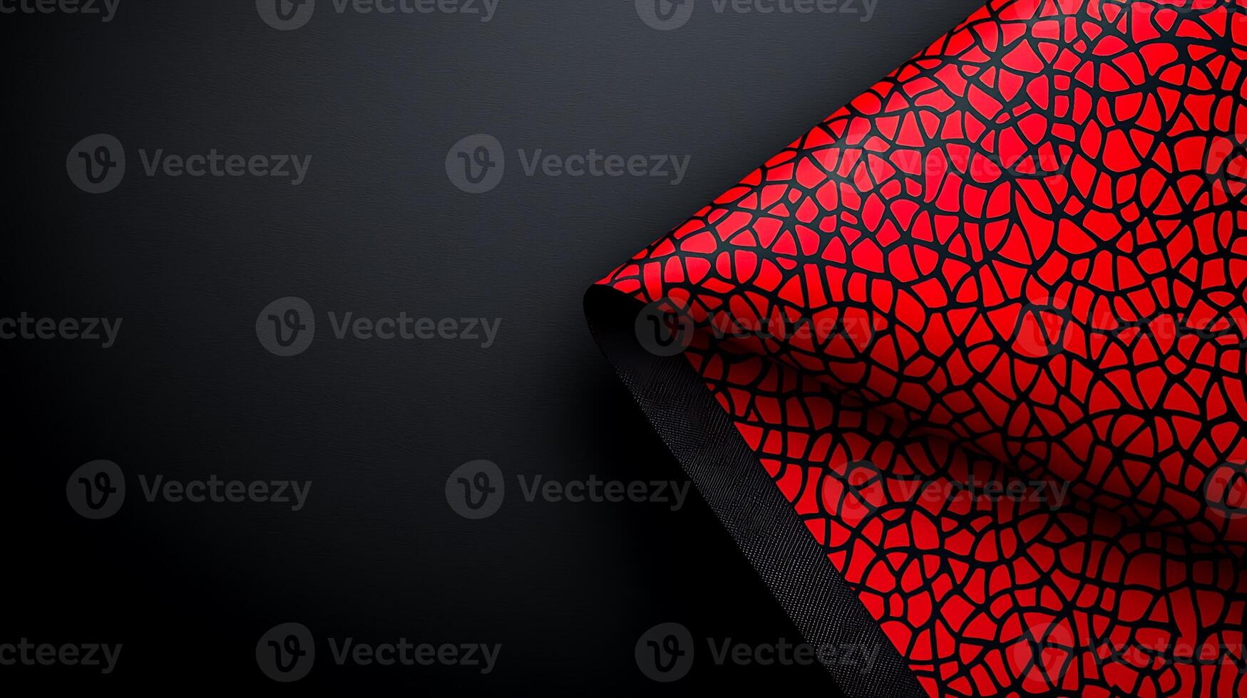 Vibrant red patterned fabric draped elegantly against a dark background showcasing texture photo