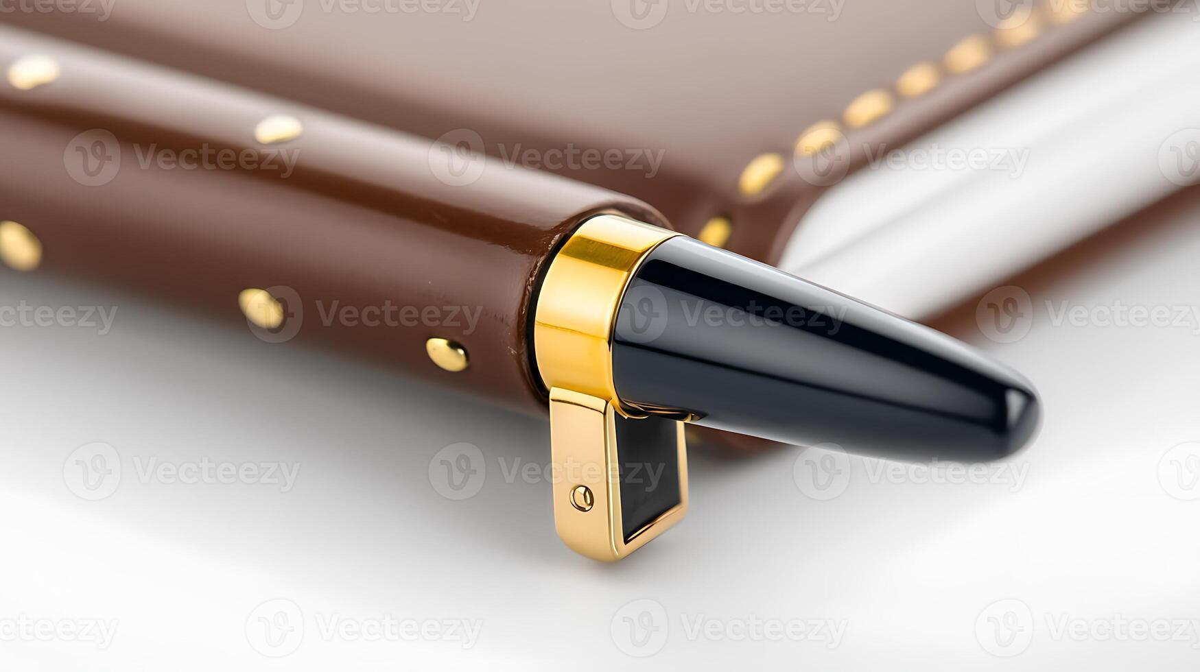 Close-up of a luxurious brown leather notebook with a gold-accented pen resting on its edge photo