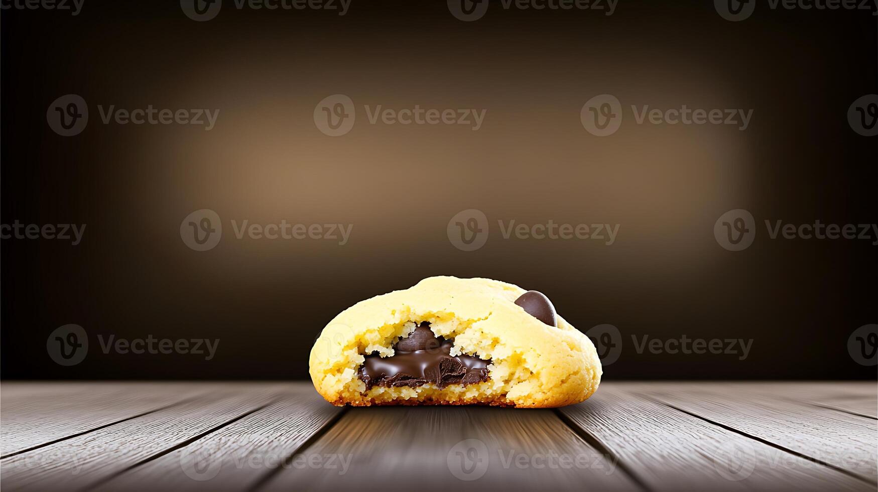 Close-up of a freshly baked chocolate chip cookie with a gooey center on a wooden table photo
