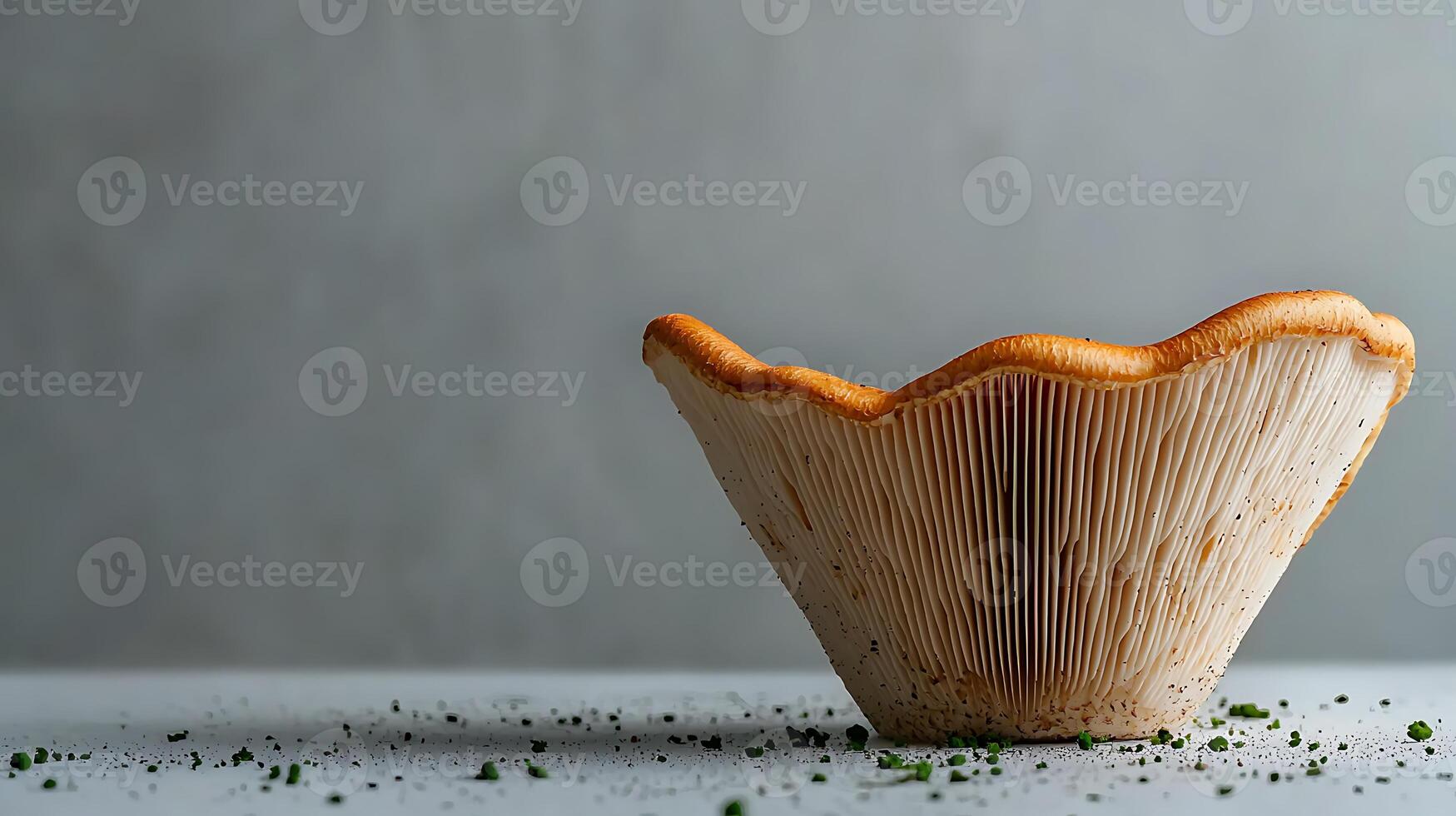 Close-up of a fresh mushroom cap on a clean surface with scattered herbs, highlighting its texture photo
