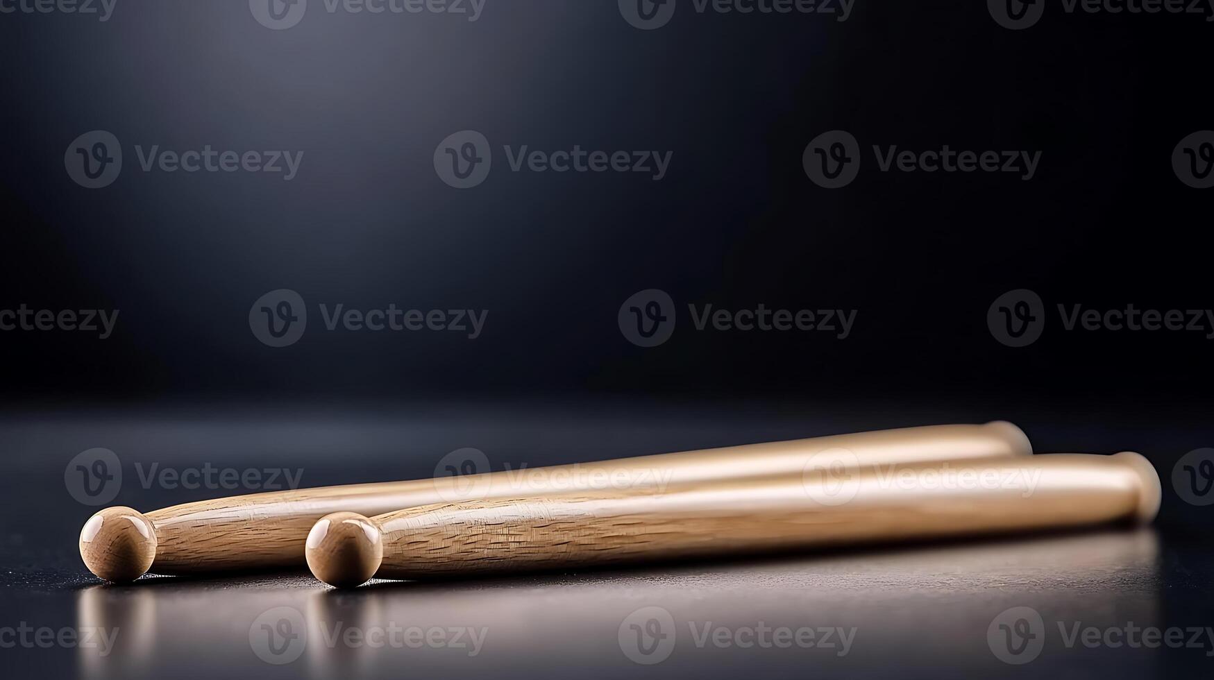 Close-up of two wooden drumsticks resting on a dark surface with soft lighting, ideal for music themes photo
