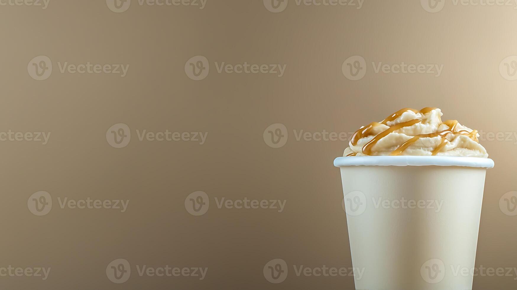 Creamy beverage topped with whipped cream and caramel sauce against a soft brown background photo