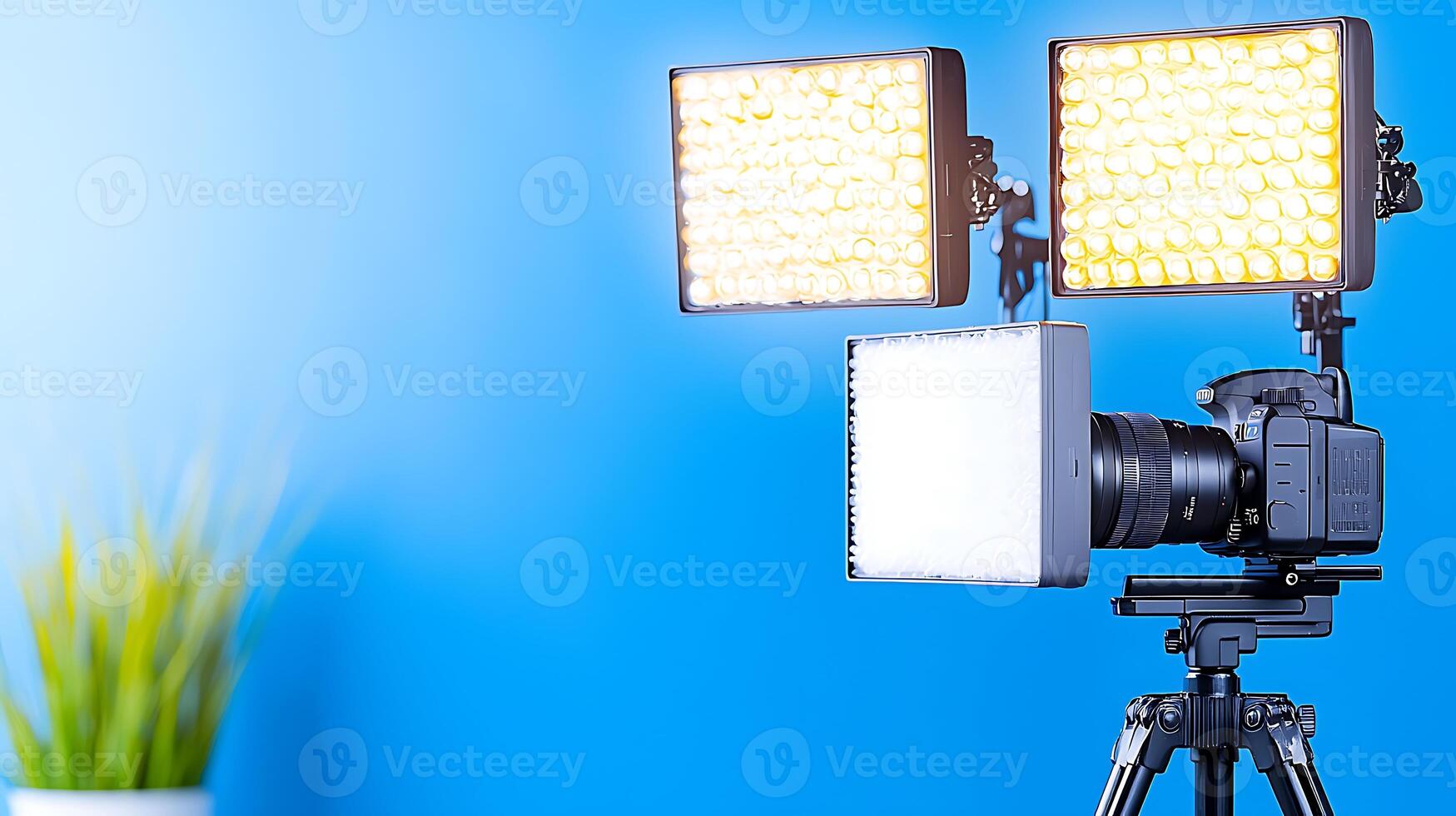 Professional camera setup with lighting equipment against a blue backdrop, ideal for photography photo
