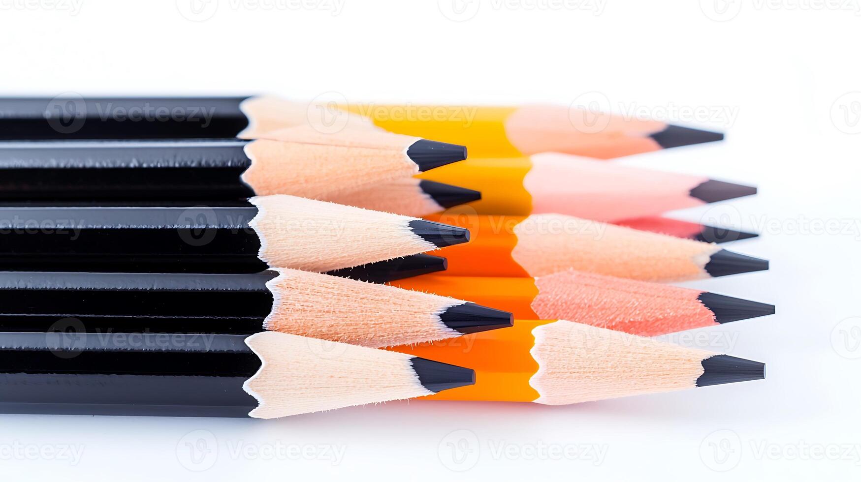 A close-up view of sharpened colored pencils arranged in a row on a white background photo