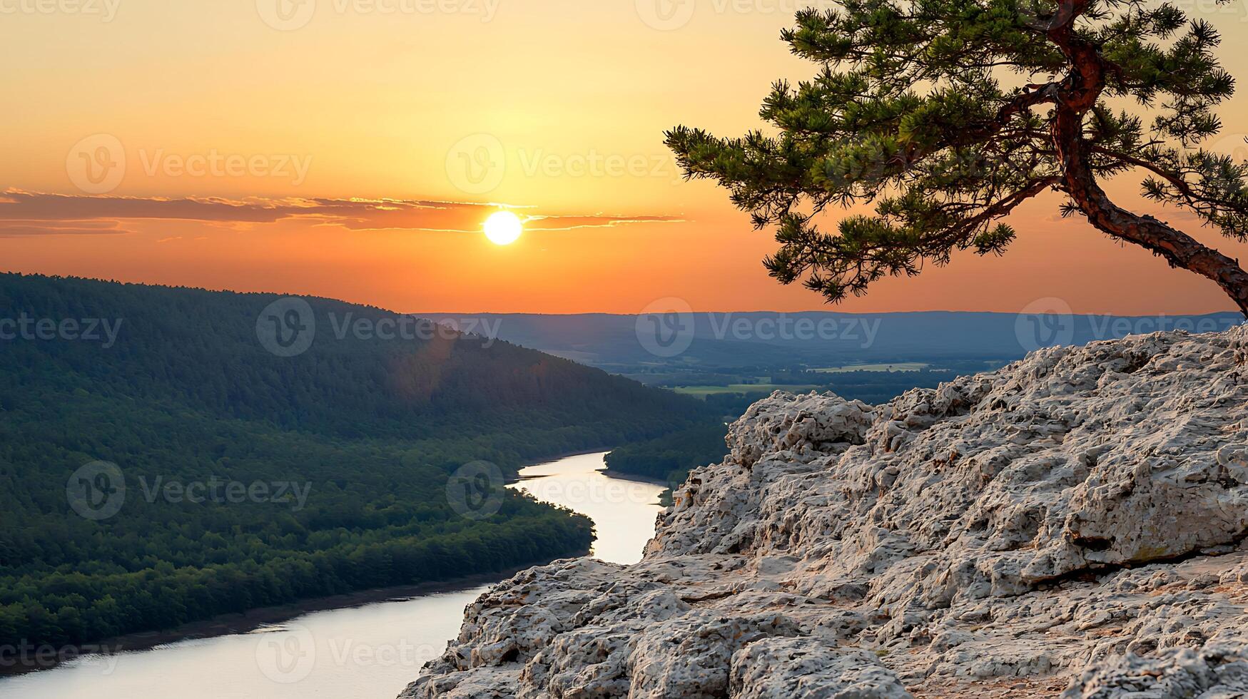 Serene sunset over a winding river with rocky cliffs and a lone tree in the foreground photo