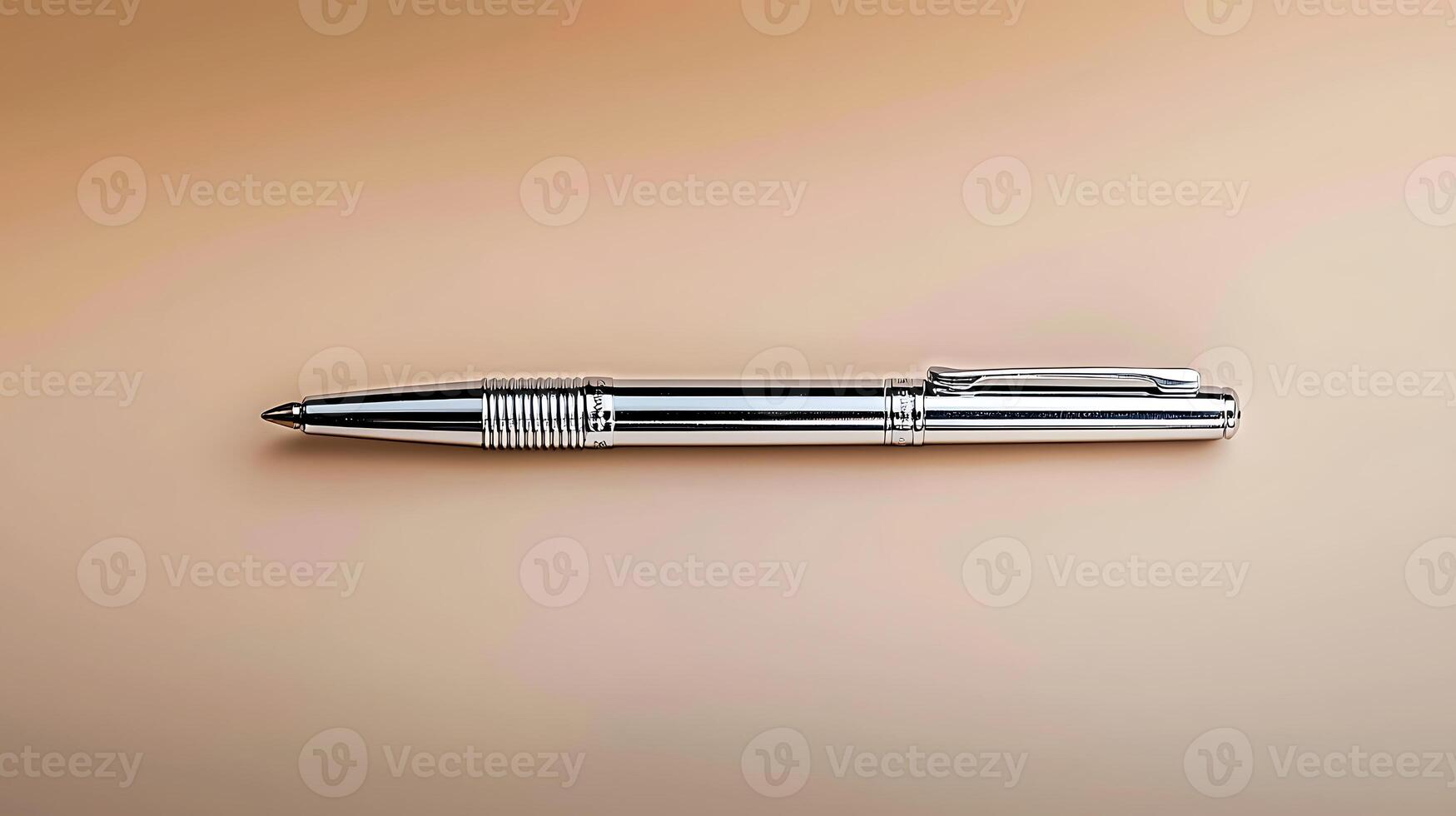 Sleek silver pen resting on a smooth beige surface, ideal for branding or office use photo