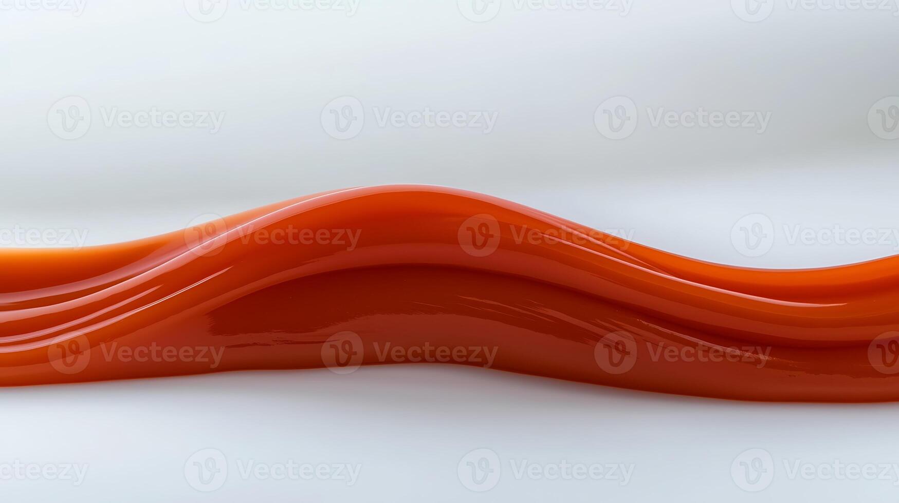 Smooth, flowing red sauce on a white surface, highlighting its glossy texture and color photo