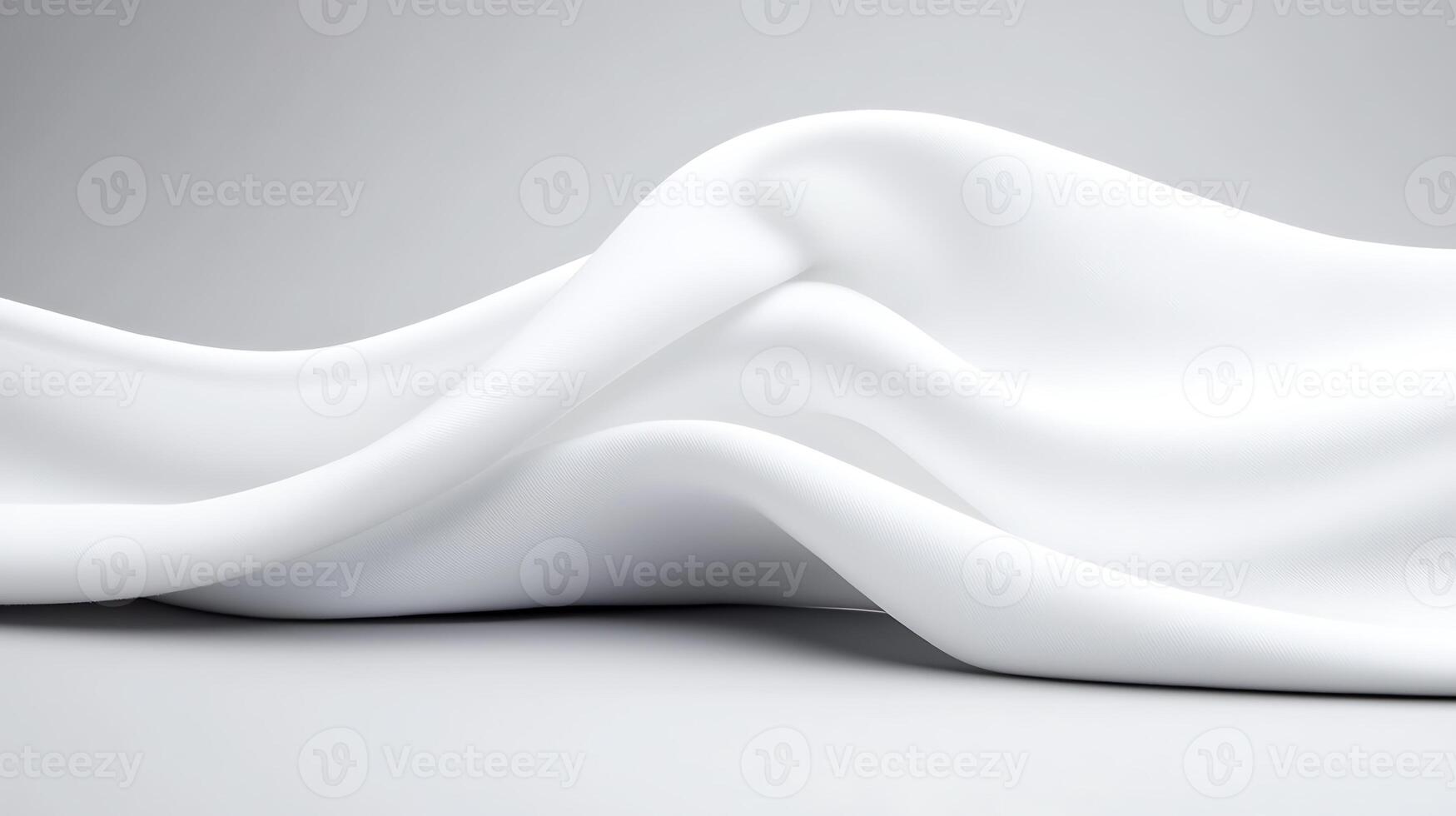 Smooth, flowing white fabric draped elegantly on a soft gray background, creating a serene ambiance photo