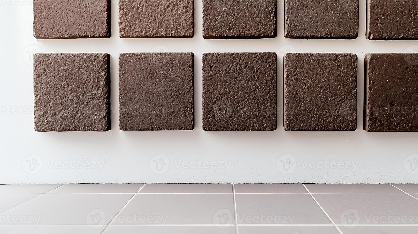 Textured brown tiles arranged in a grid pattern on a clean wall, showcasing modern design elements photo