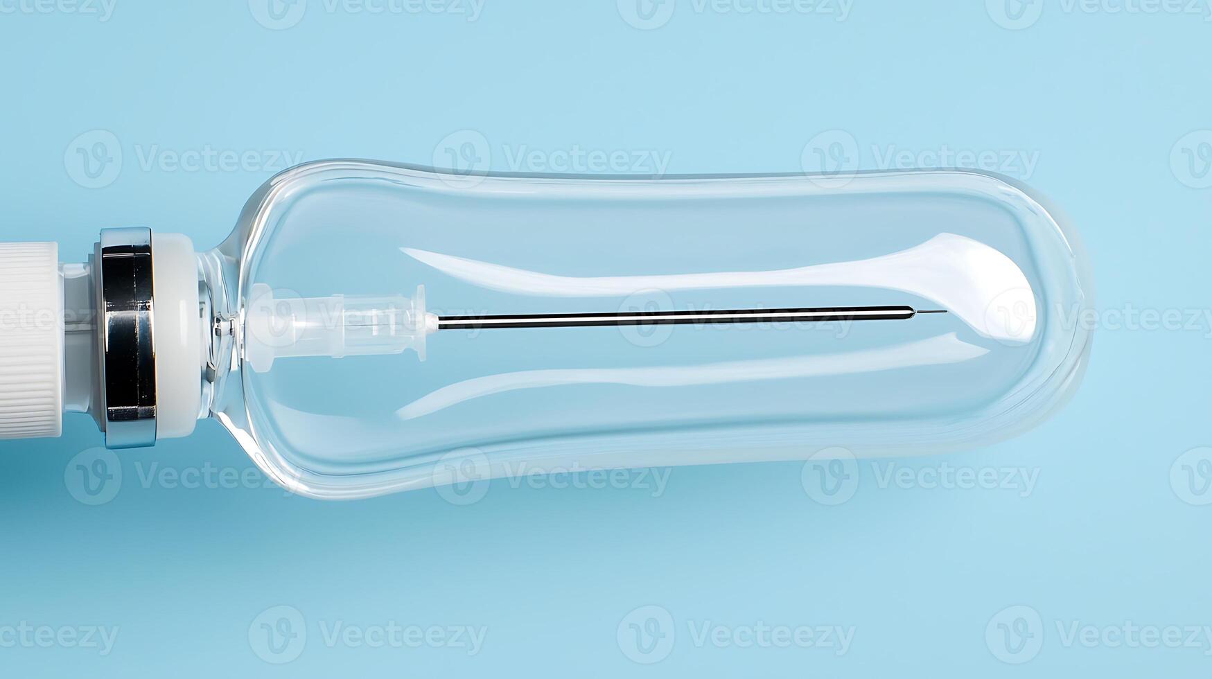 Transparent medical syringe on a light blue background, showcasing its design and functionality photo