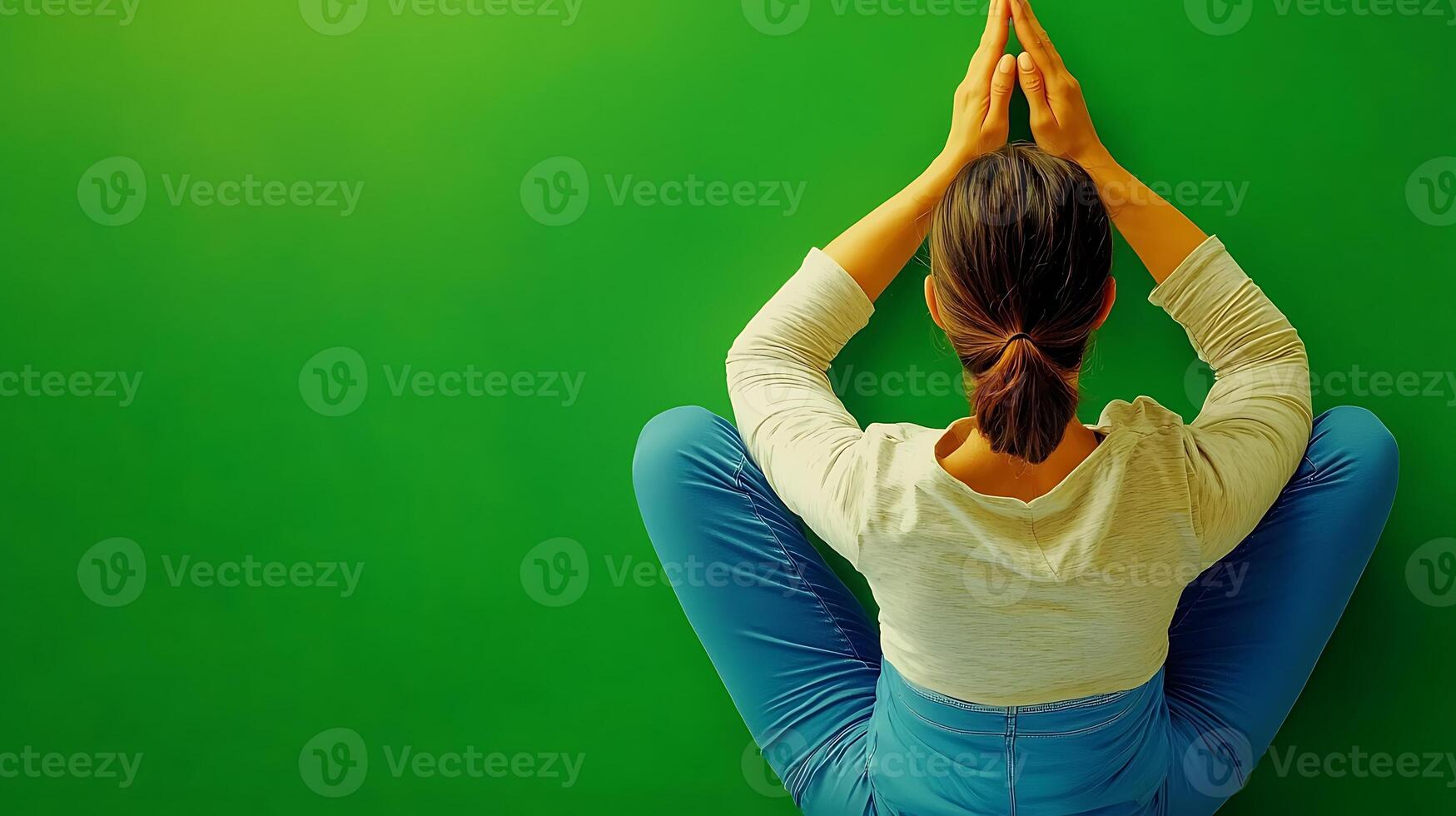 Woman practicing yoga in a serene indoor space with a vibrant green backdrop photo