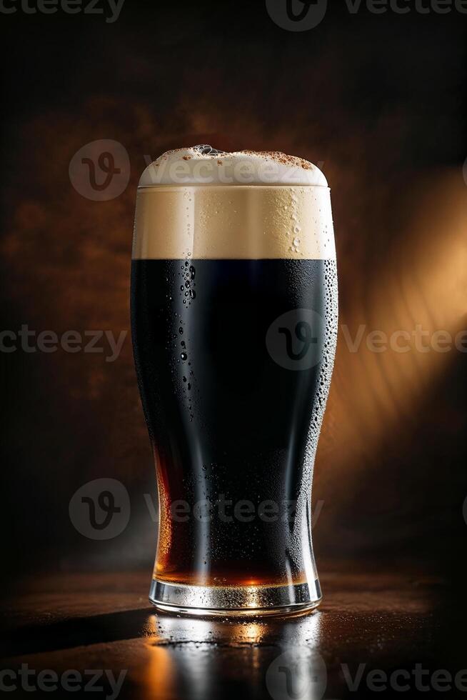 Cold glass of dark beer with foam and cinnamon on dark background photo