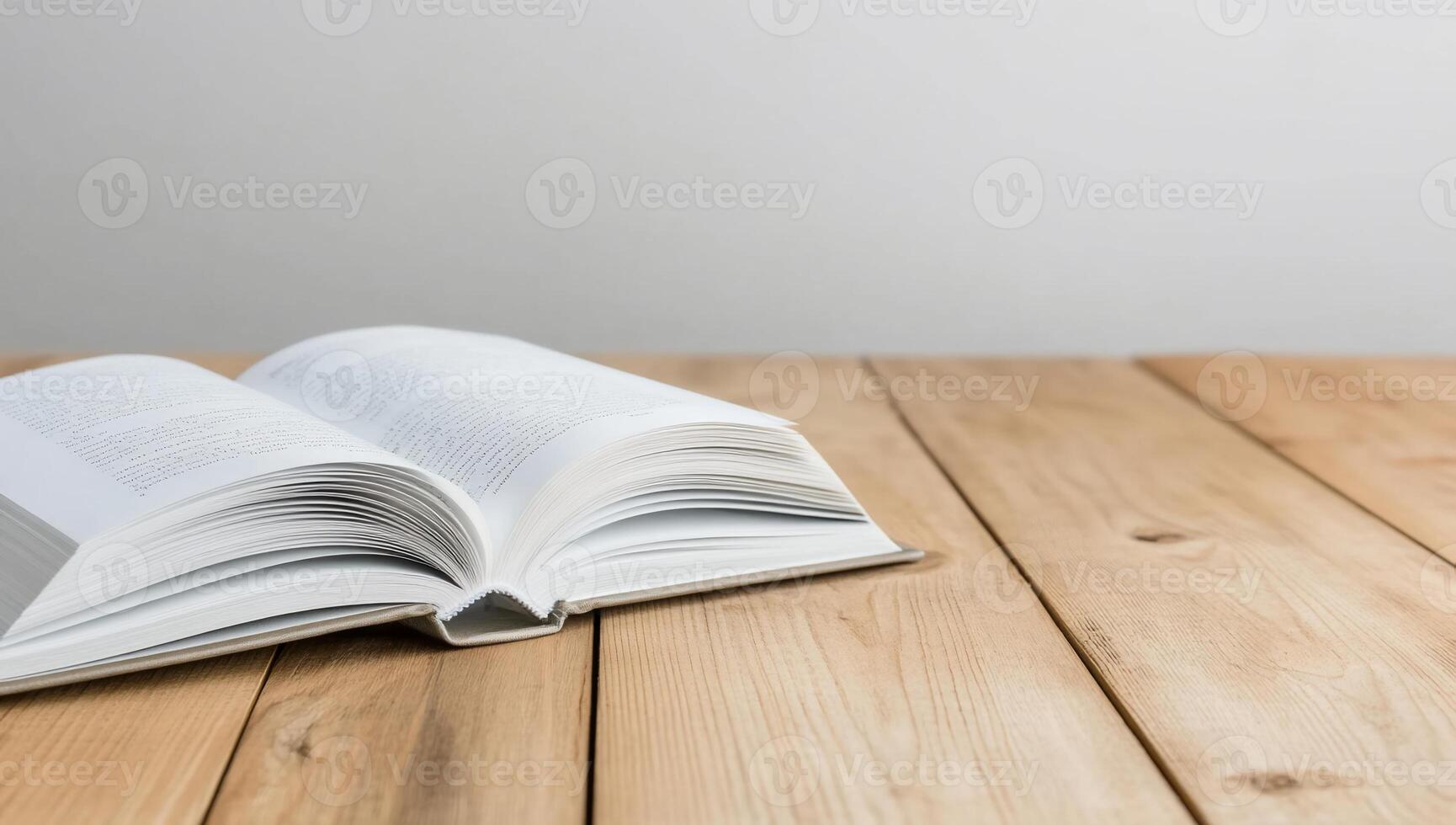 An open book resting on a wooden table, inviting reading and knowledge. photo