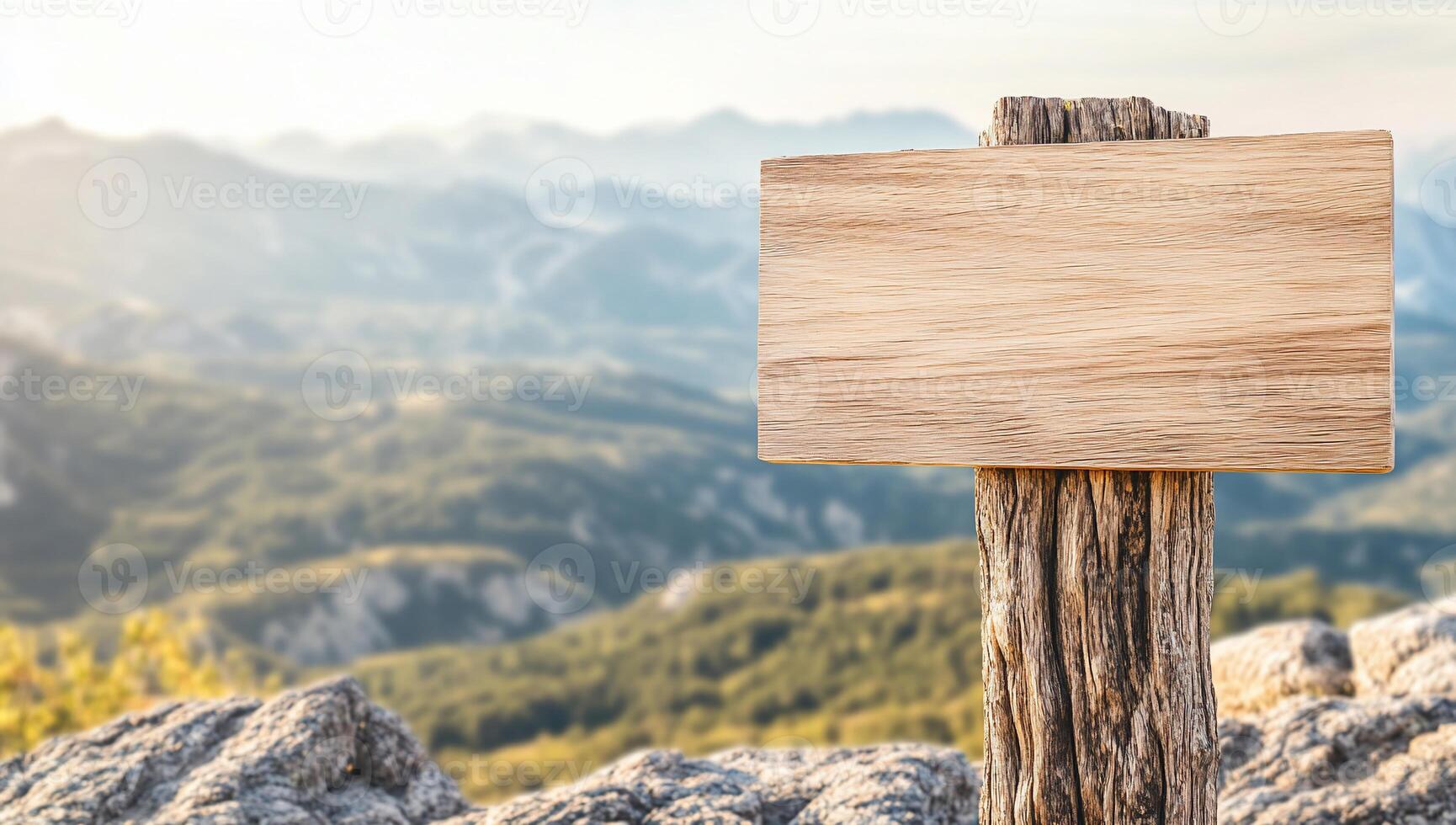 A wooden signpost stands against a scenic mountain landscape. photo