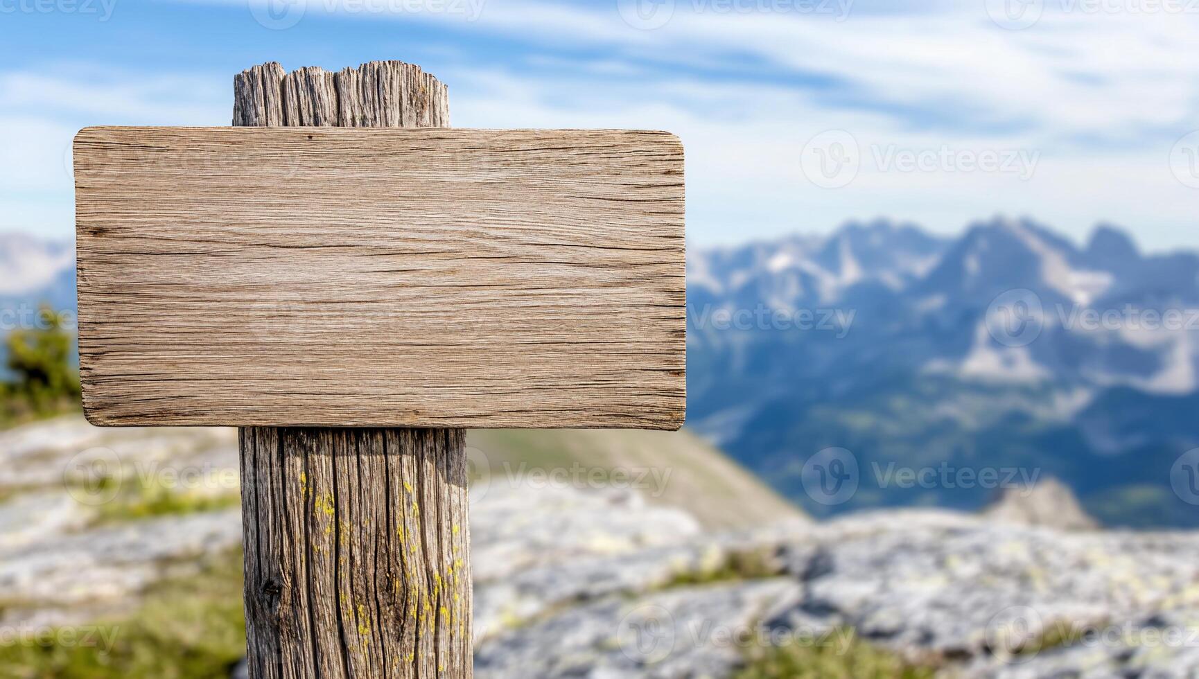 Wooden sign on top of mountain with blue sky photo