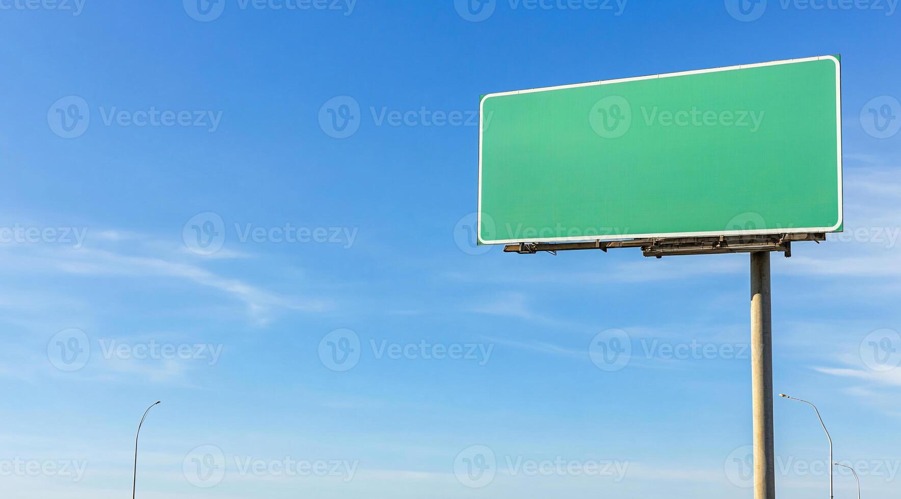 A blank billboard against a blue sky, ready for advertising. photo