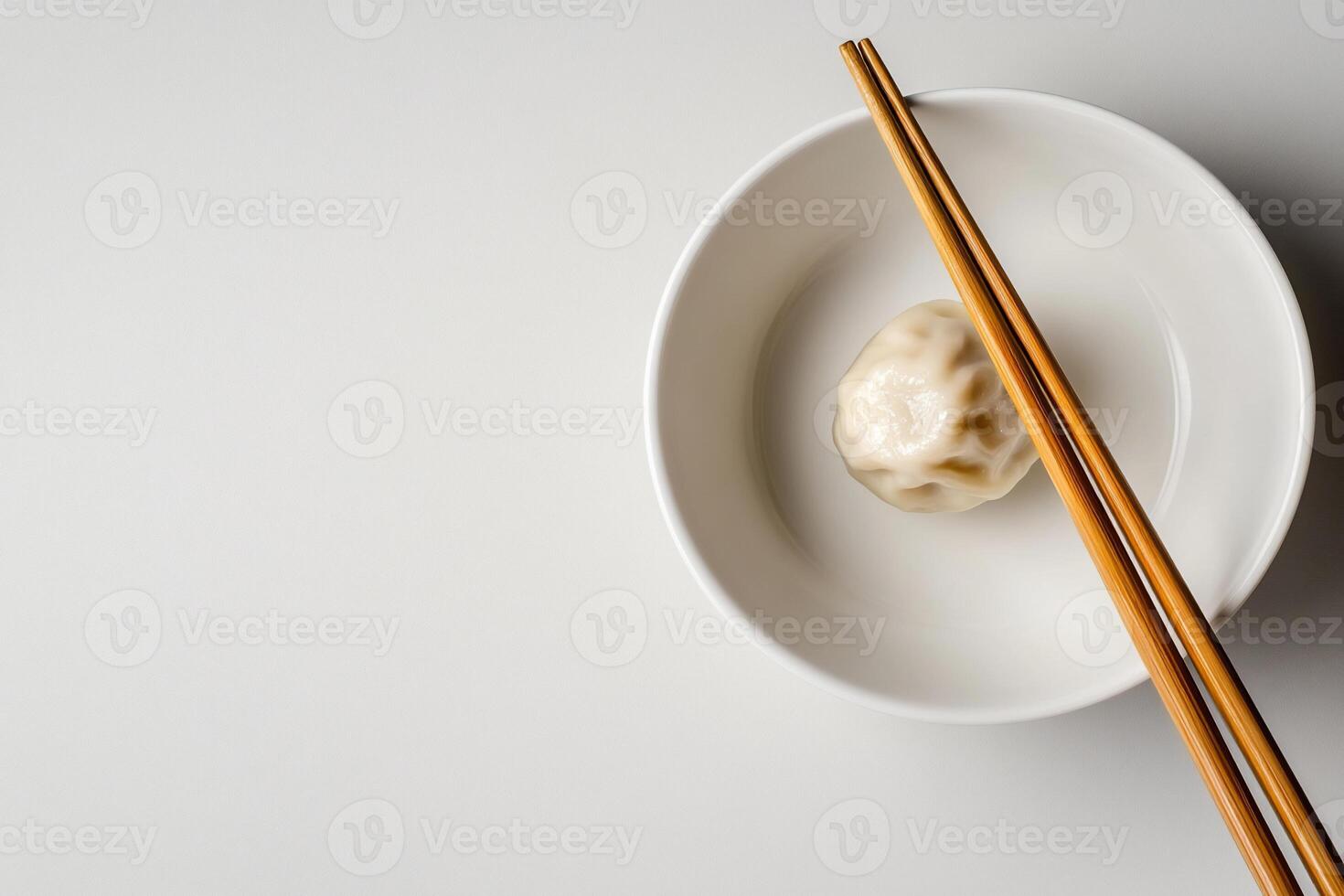 Dumplings in a bowl with chopsticks on a white background photo