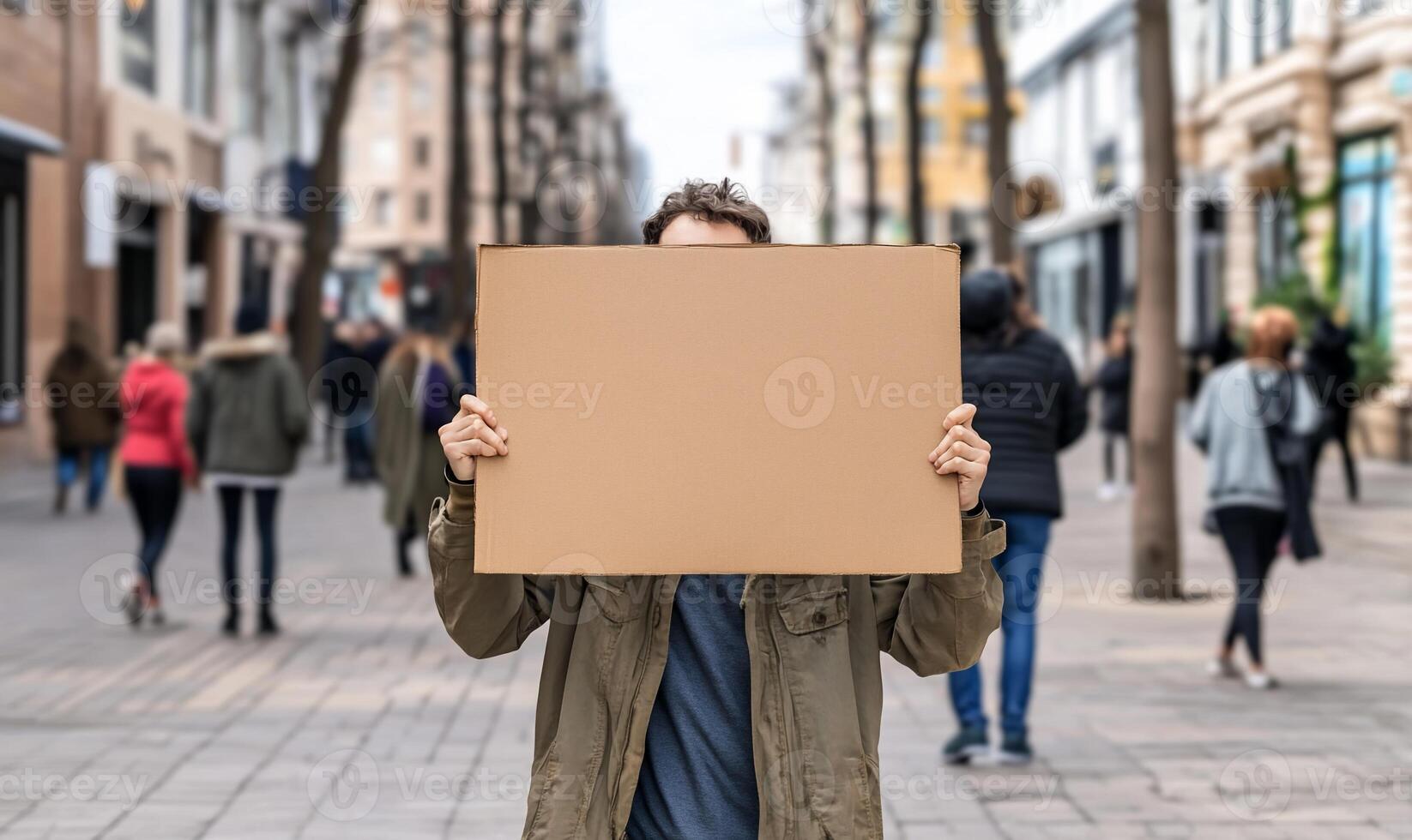 Man holding a cardboard sign on the street photo