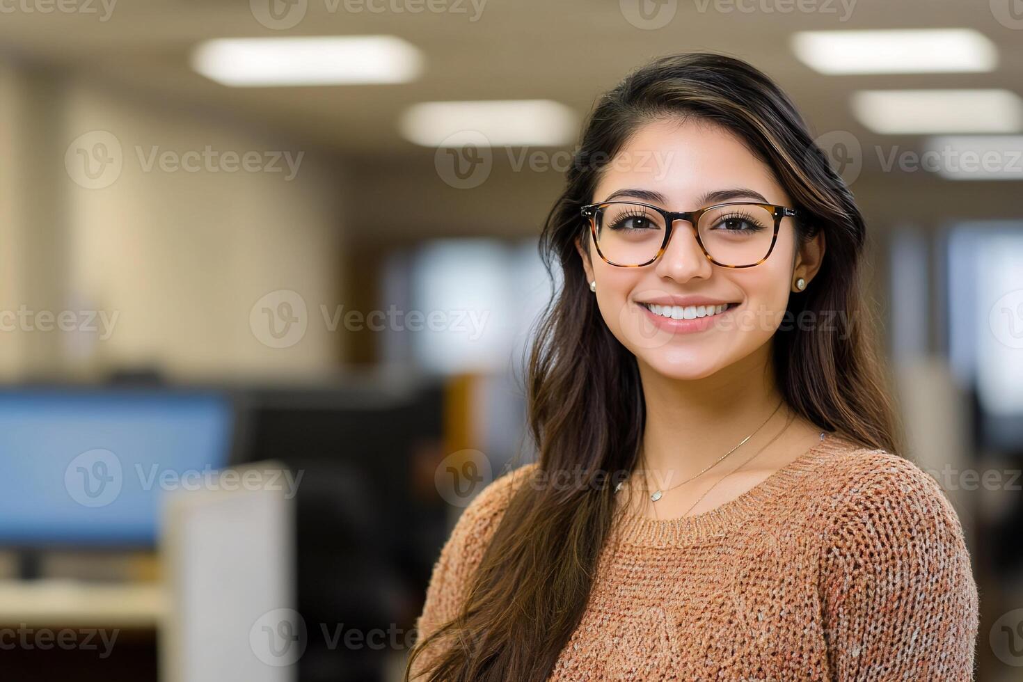 A smiling woman in an office with glasses photo