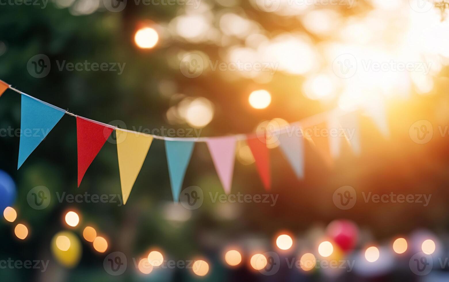 Colorful party bunting with soft lights at sunset. photo