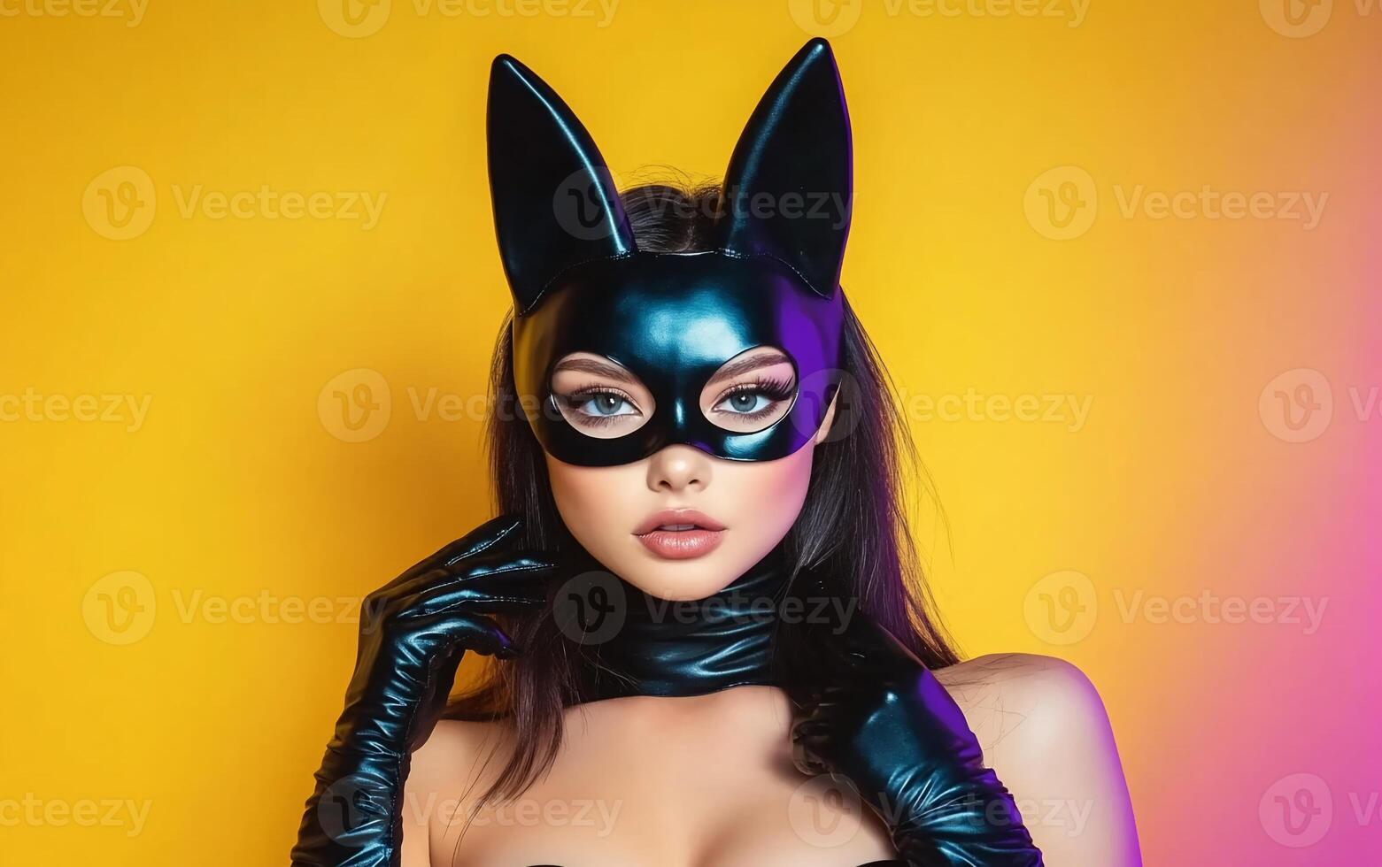 Sexy woman in black cat mask and latex gloves on yellow background photo