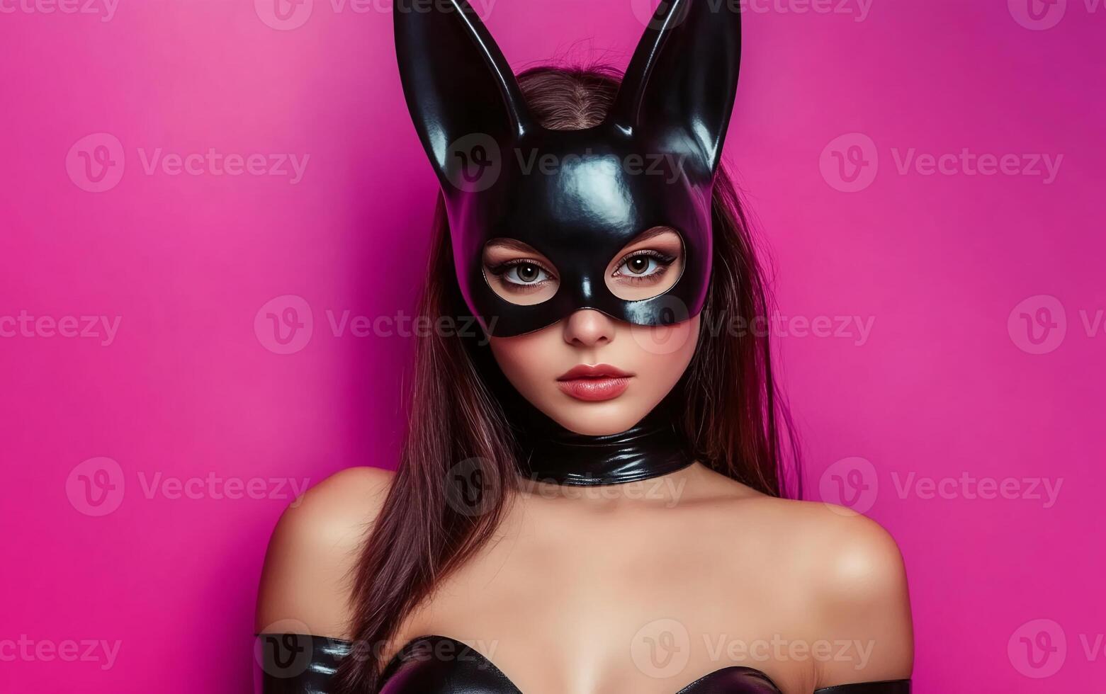 A woman in a black cat mask and latex outfit photo