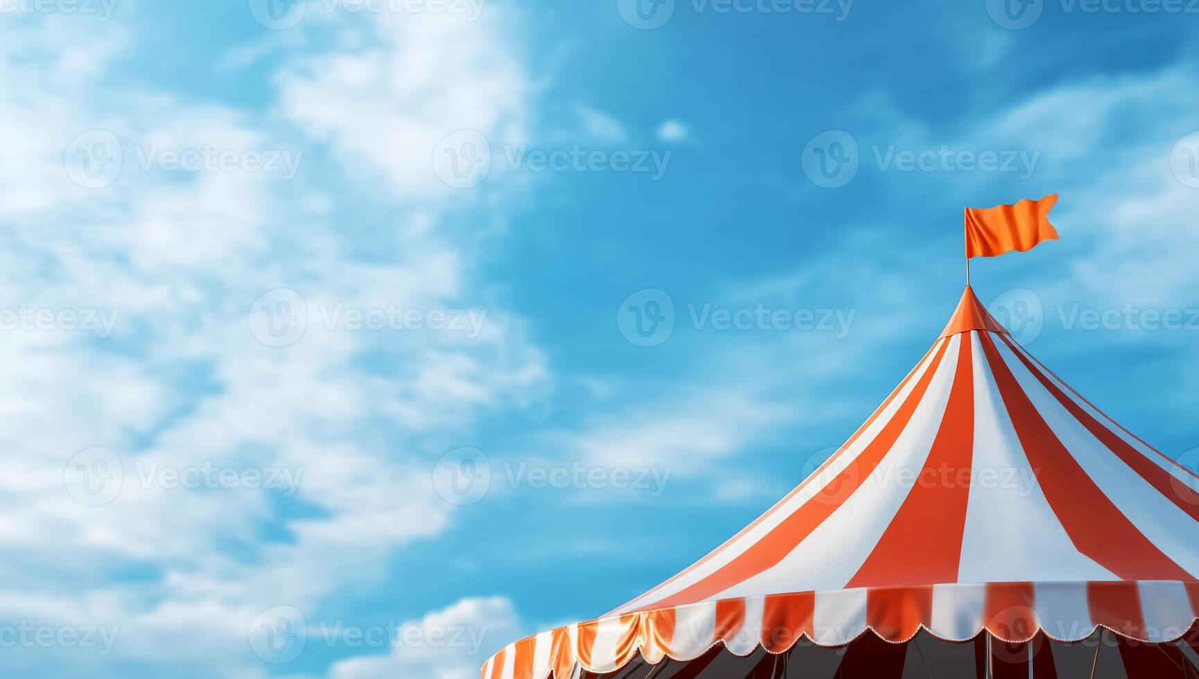 A colorful circus tent under a bright blue sky with fluffy clouds. photo