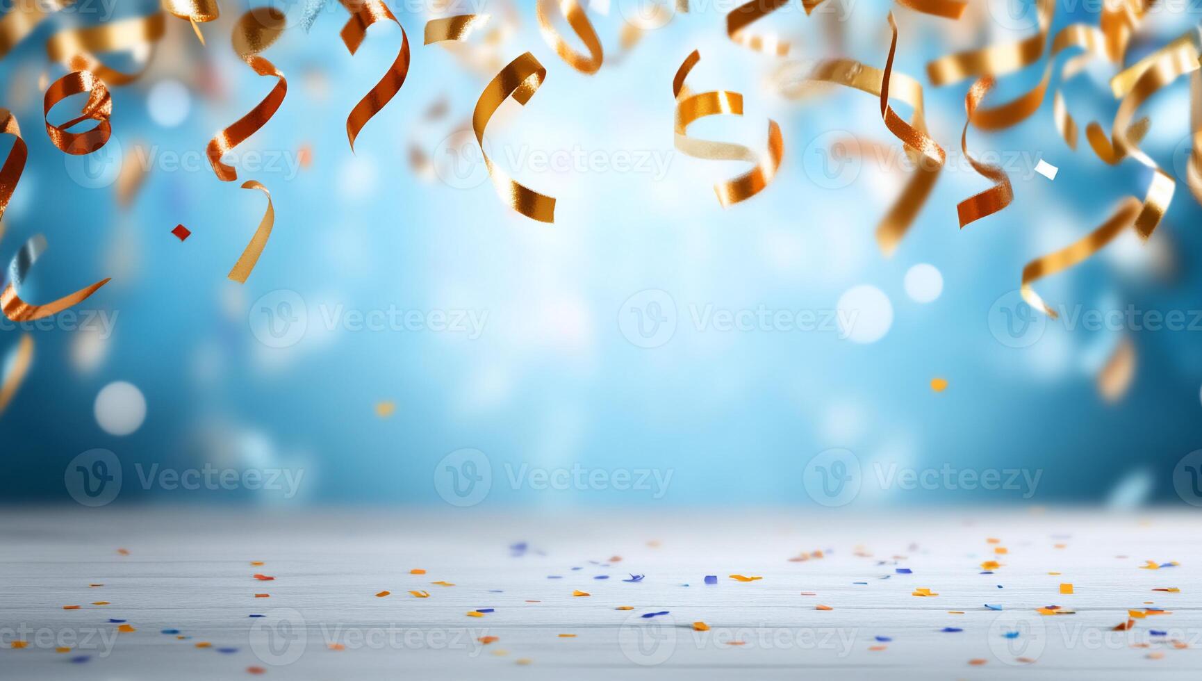 Colorful confetti and ribbons falling against a bright blue background. photo