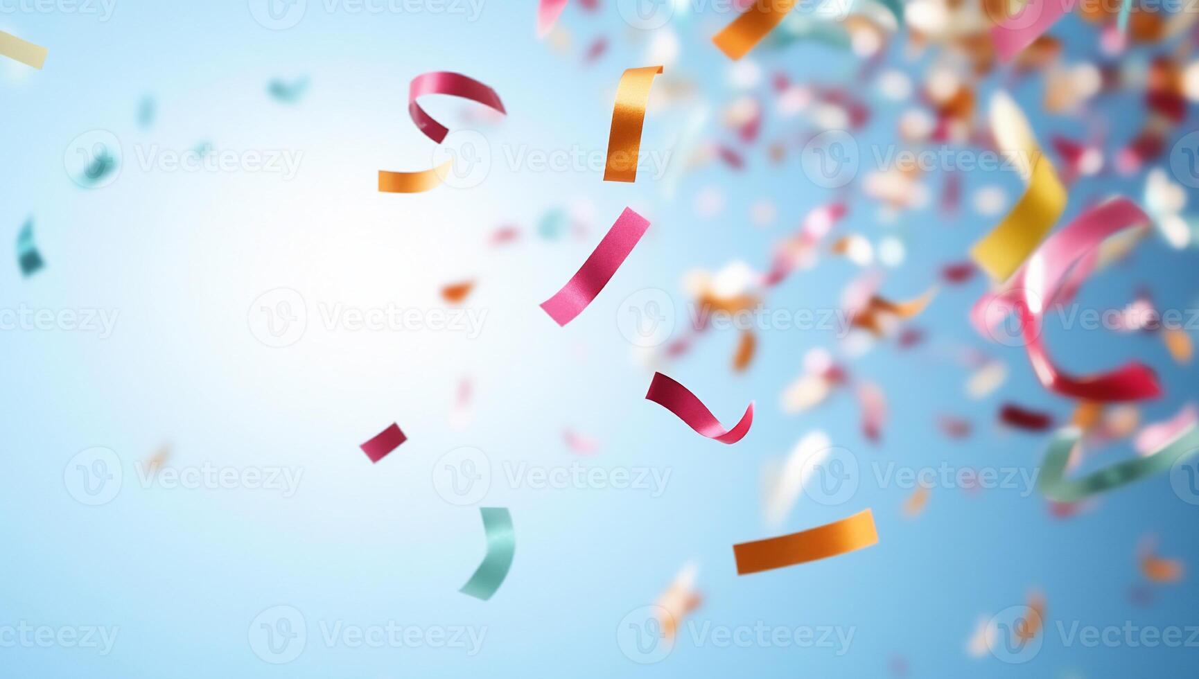 Colorful confetti falling against a bright blue background. photo